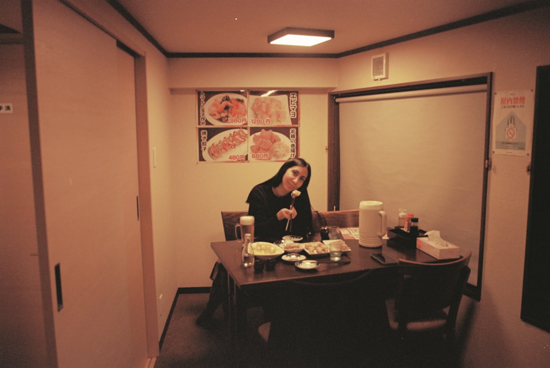 office テレビ 色 おかしい Woman enjoys a meal at a table in a restaurant.