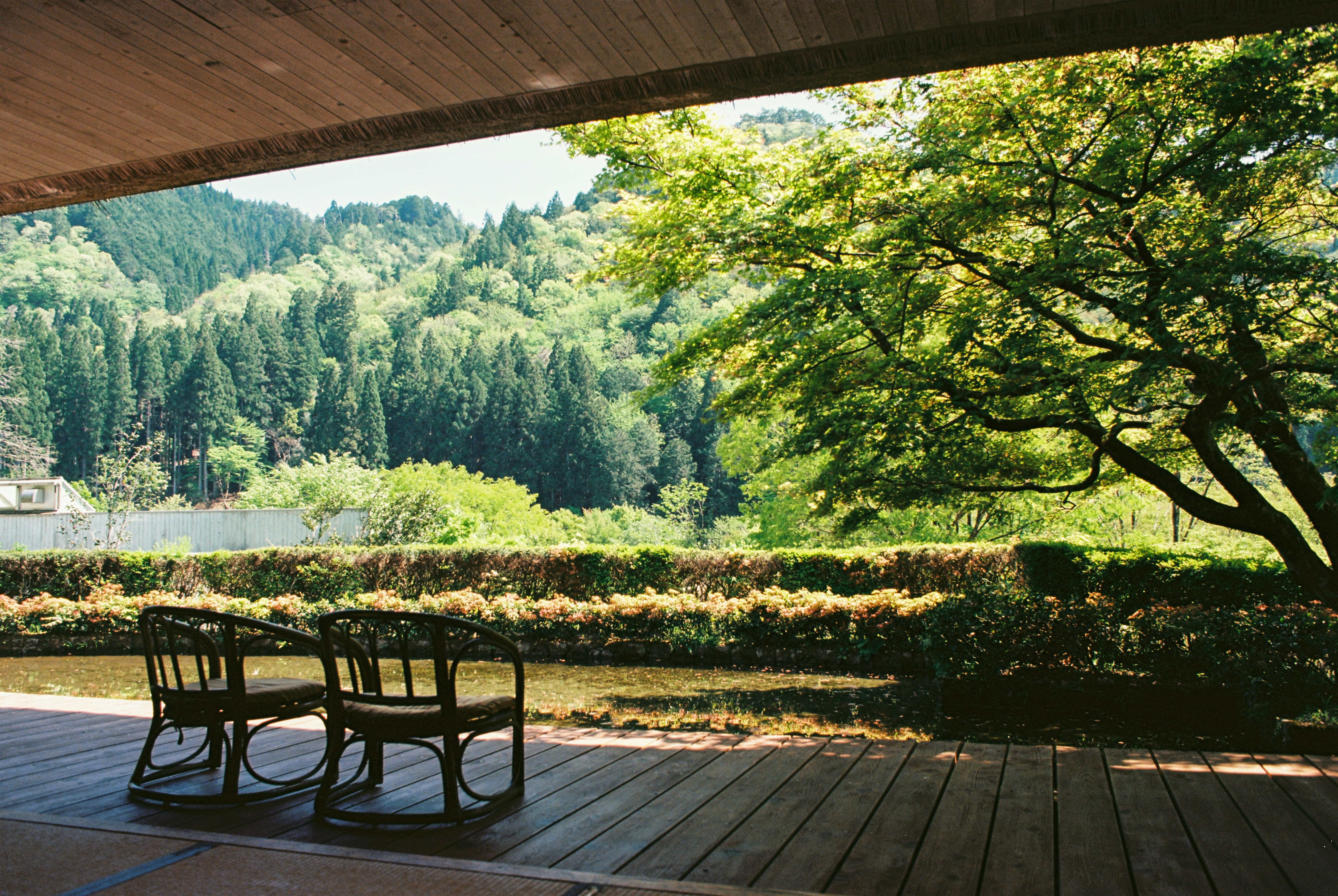 Two chairs overlook a scenic mountain view.