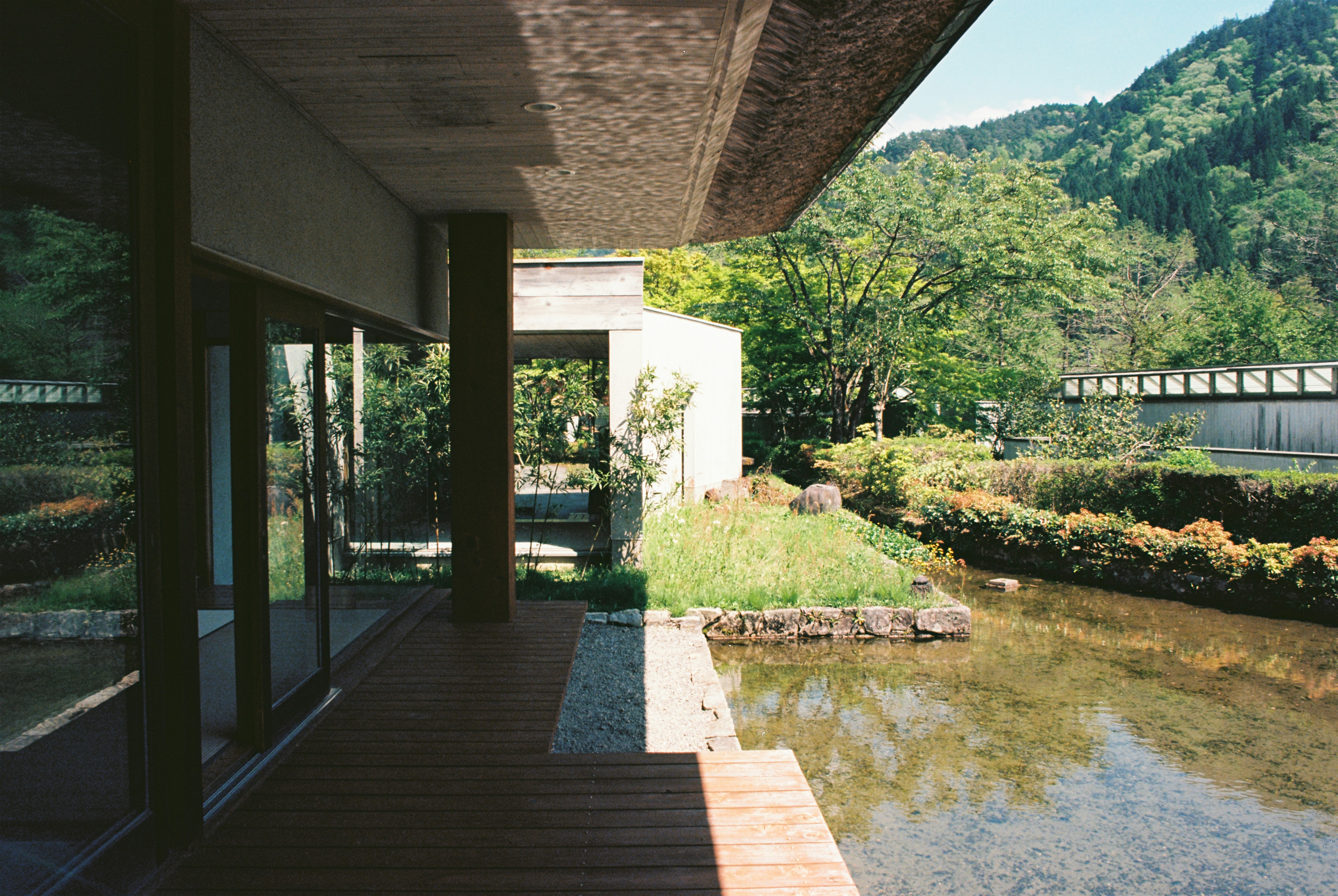 A modern building overlooks a serene landscape.