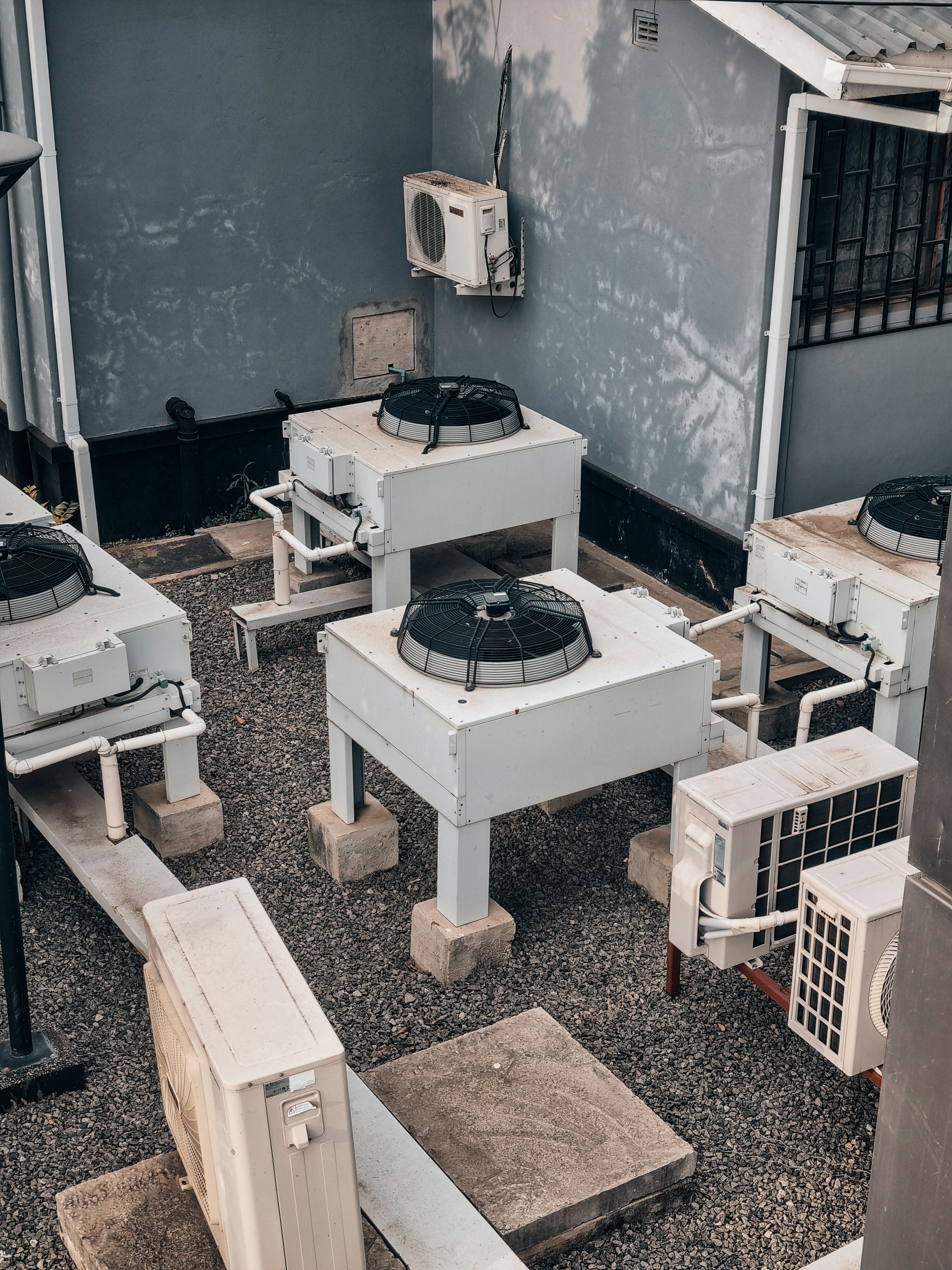 Air conditioning units are shown outdoors on concrete.