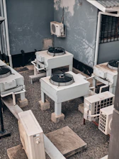 Air conditioning units are shown outdoors on concrete.