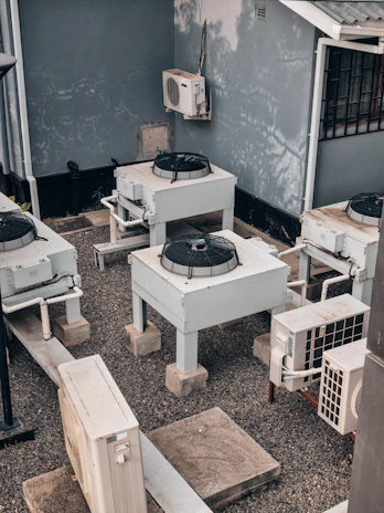 Air conditioning units are shown outdoors on concrete.