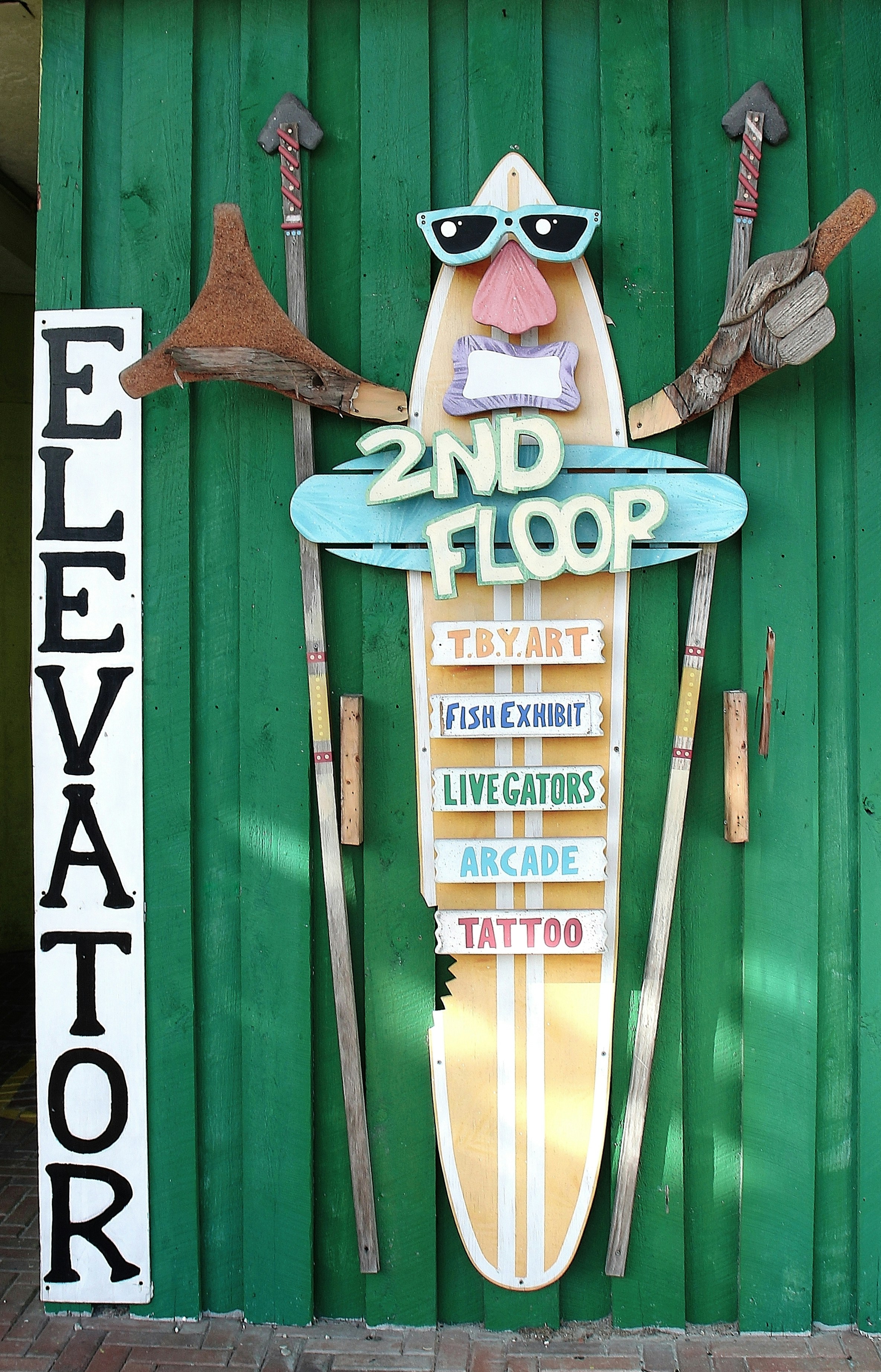 A funky sign points the way to the second floor.