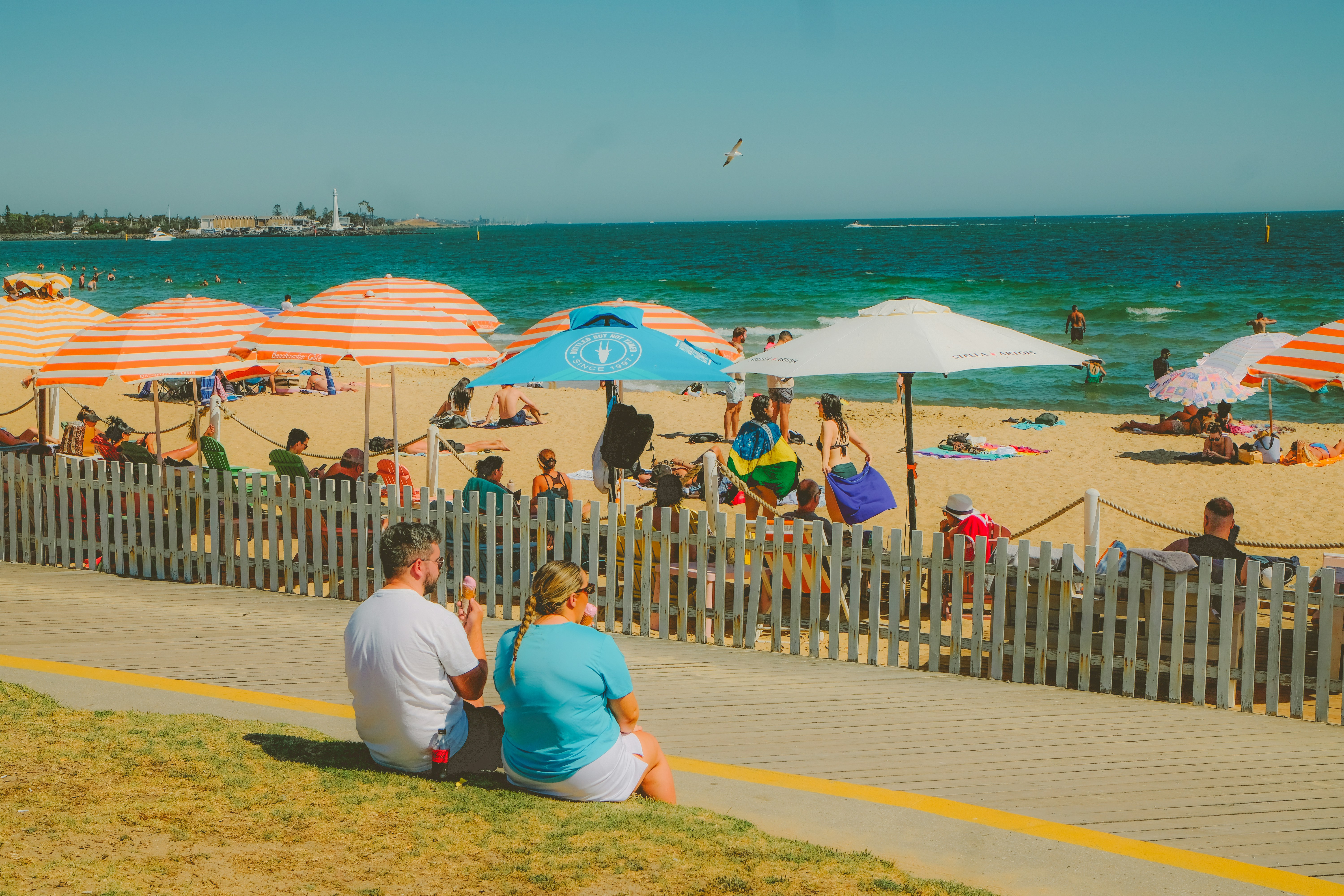 People enjoy a sunny day at the beach.