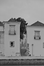 Houses frame a narrow street leading upwards.