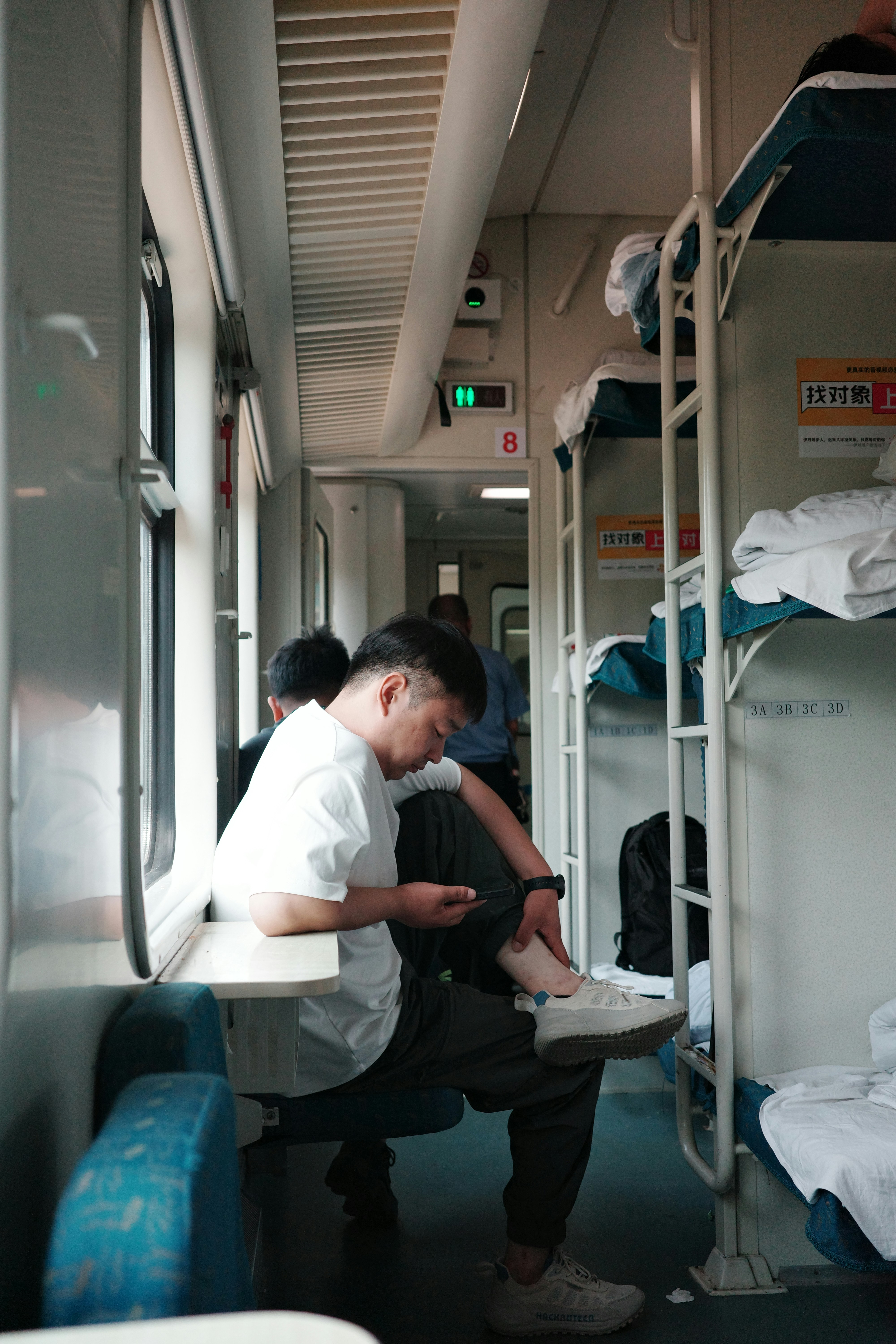 A man uses his phone on a train.