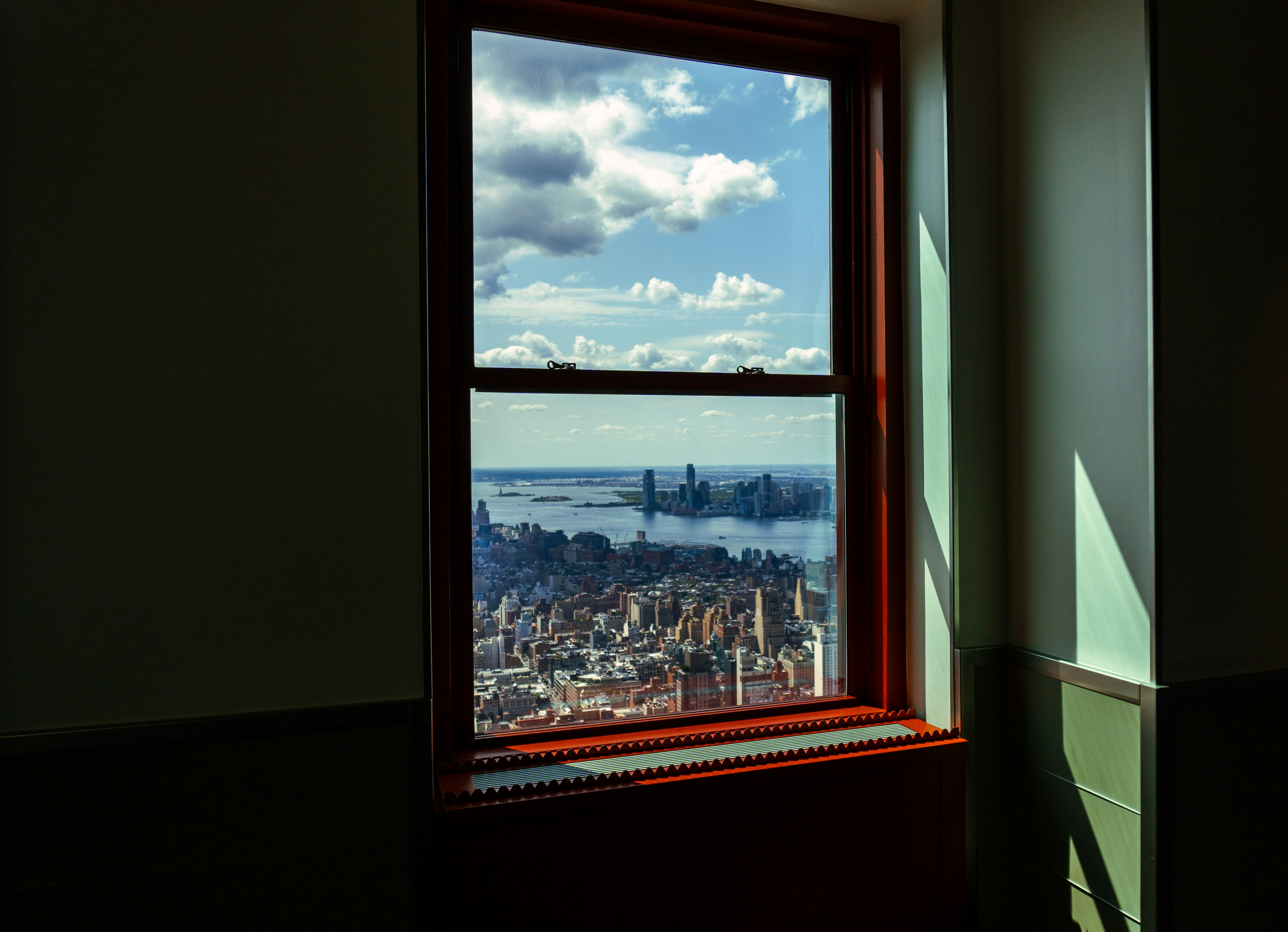 A window offers a stunning view of the city.