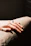 A hand rests with a ring in soft sunlight.