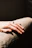 A hand rests with a ring in soft sunlight.