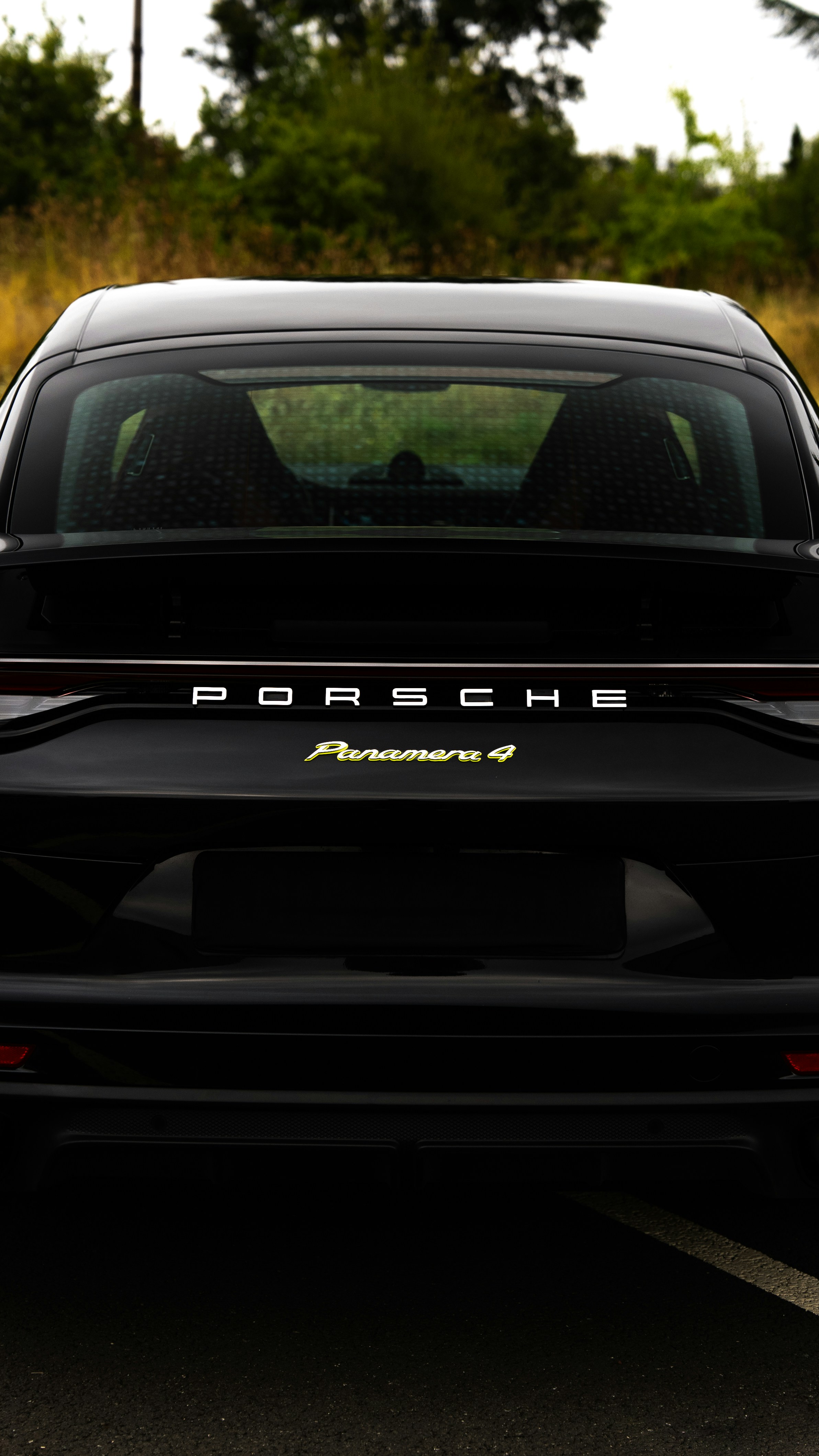 Black porsche panamera 4 from the rear.