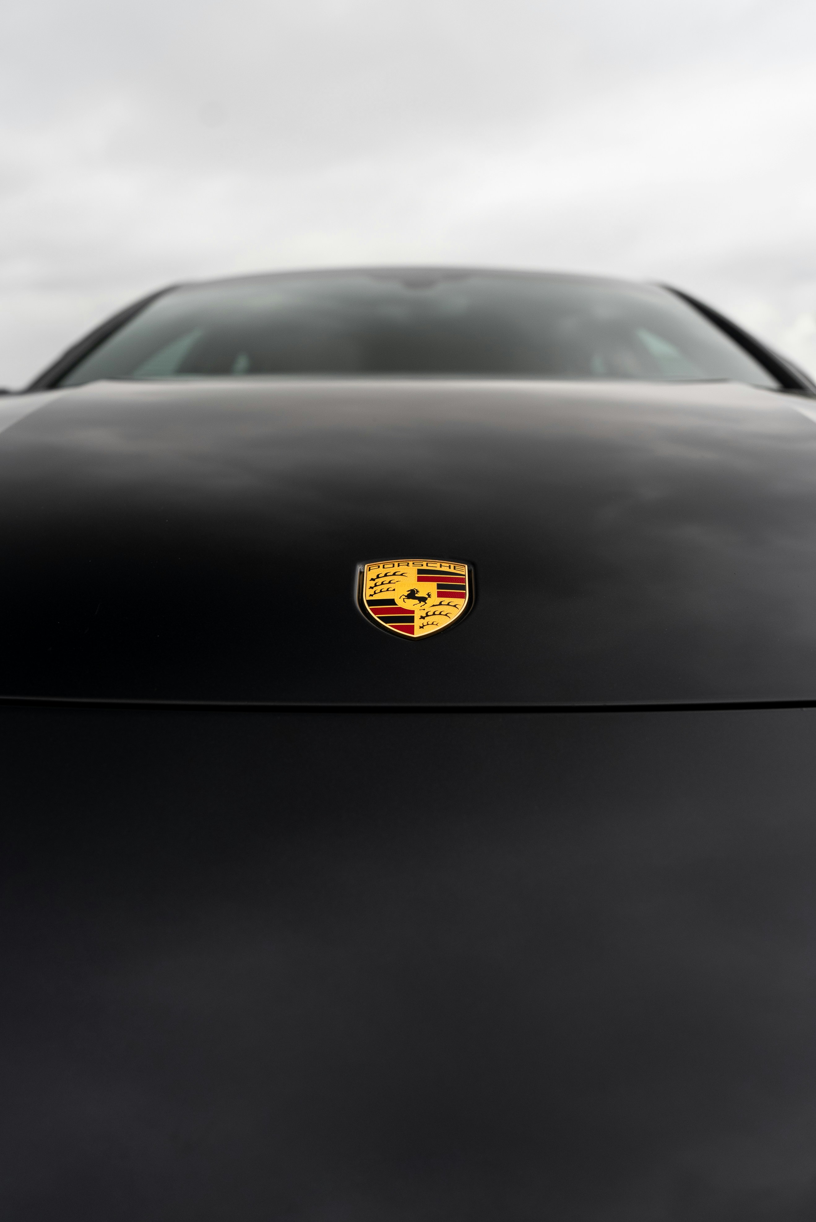 A close-up view of a black porsche.
