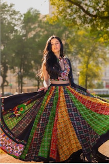 Woman twirling in colorful traditional indian attire.