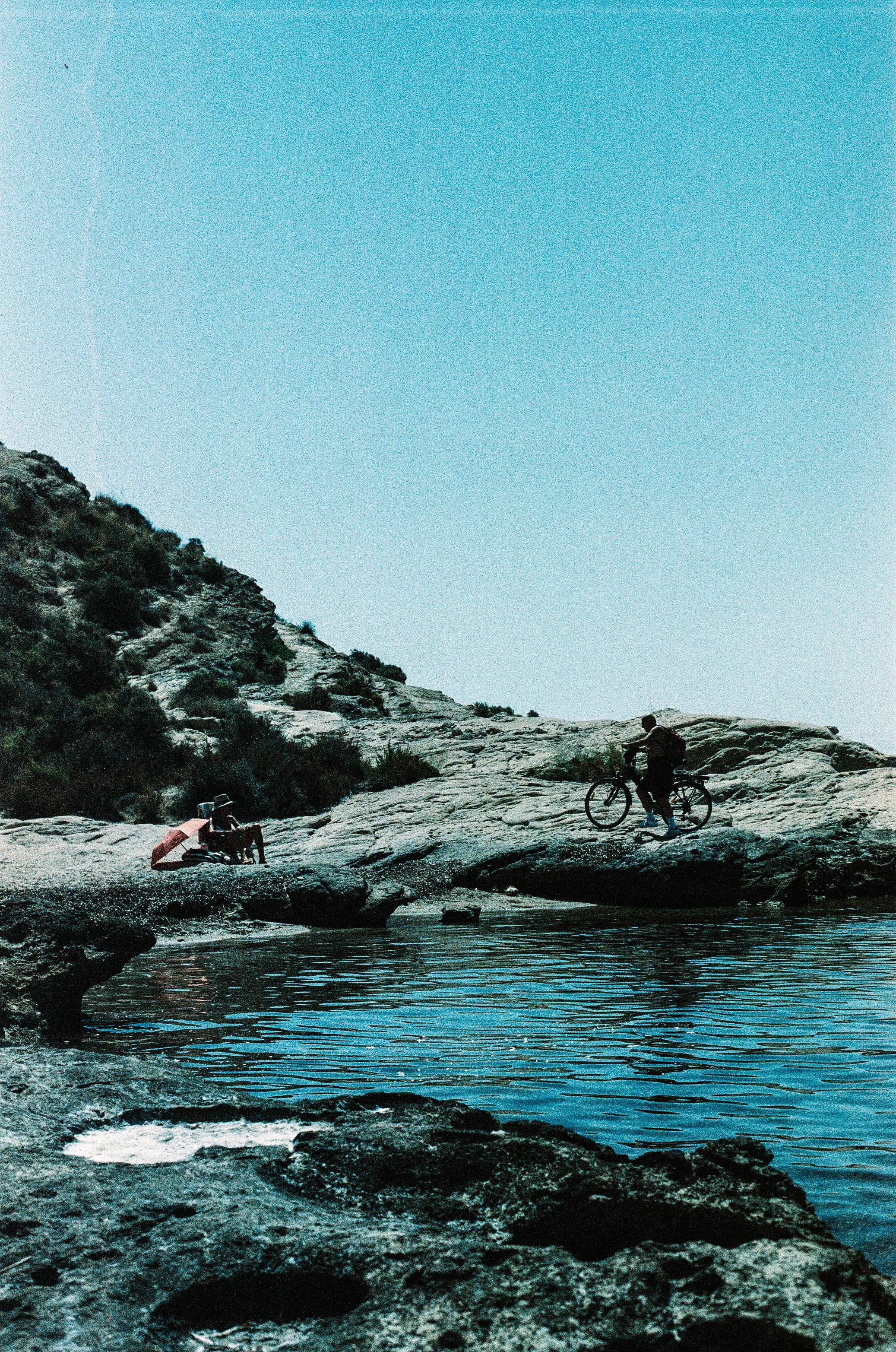 People enjoy the coastal scenery on a sunny day.
