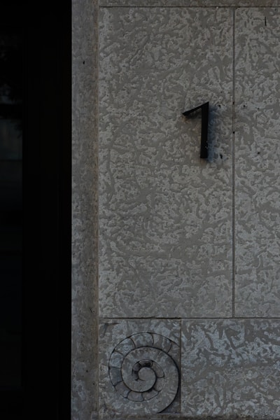 Number "1" is on a textured stone wall.