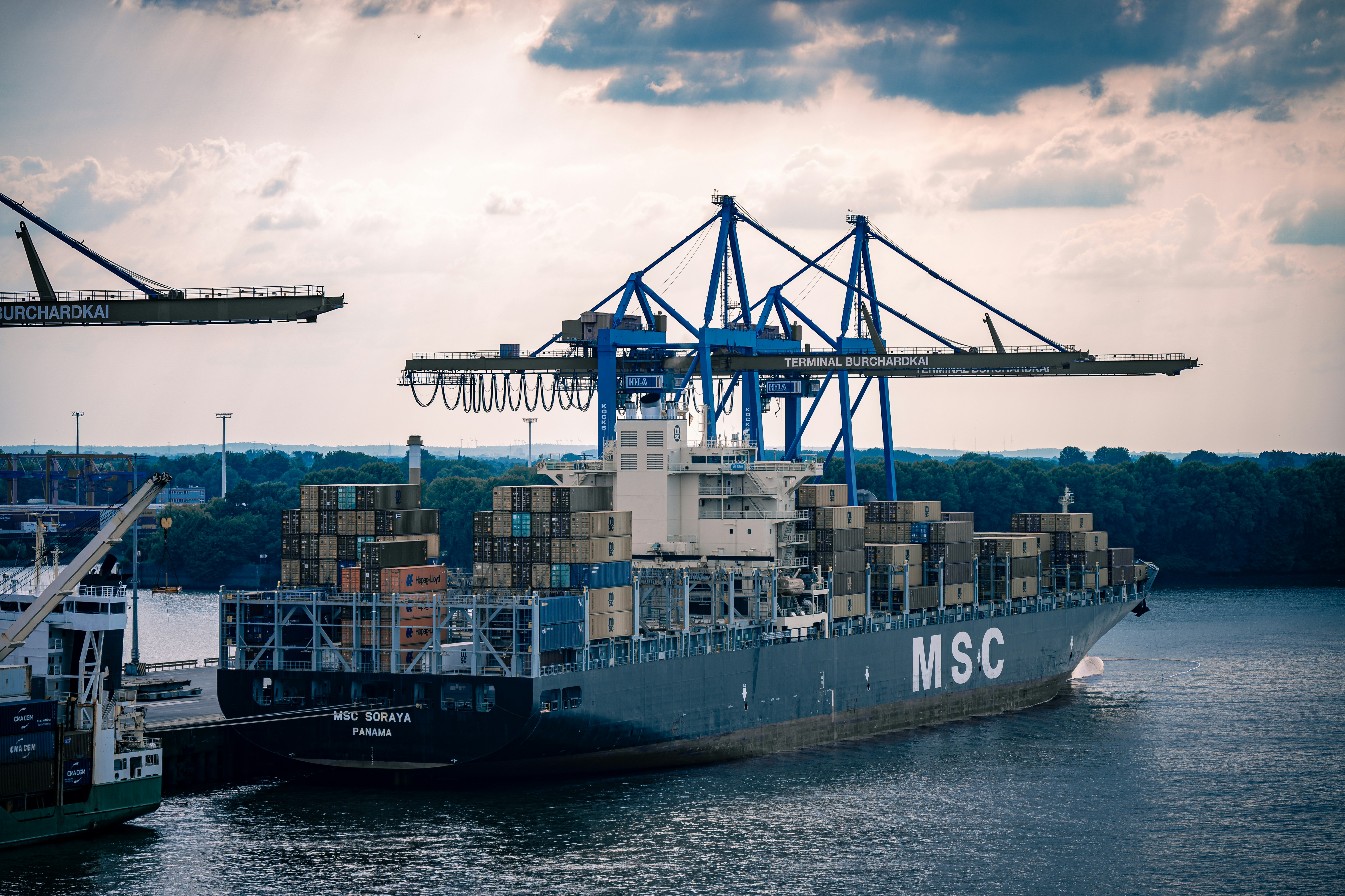 Cargo ship loading at busy port
