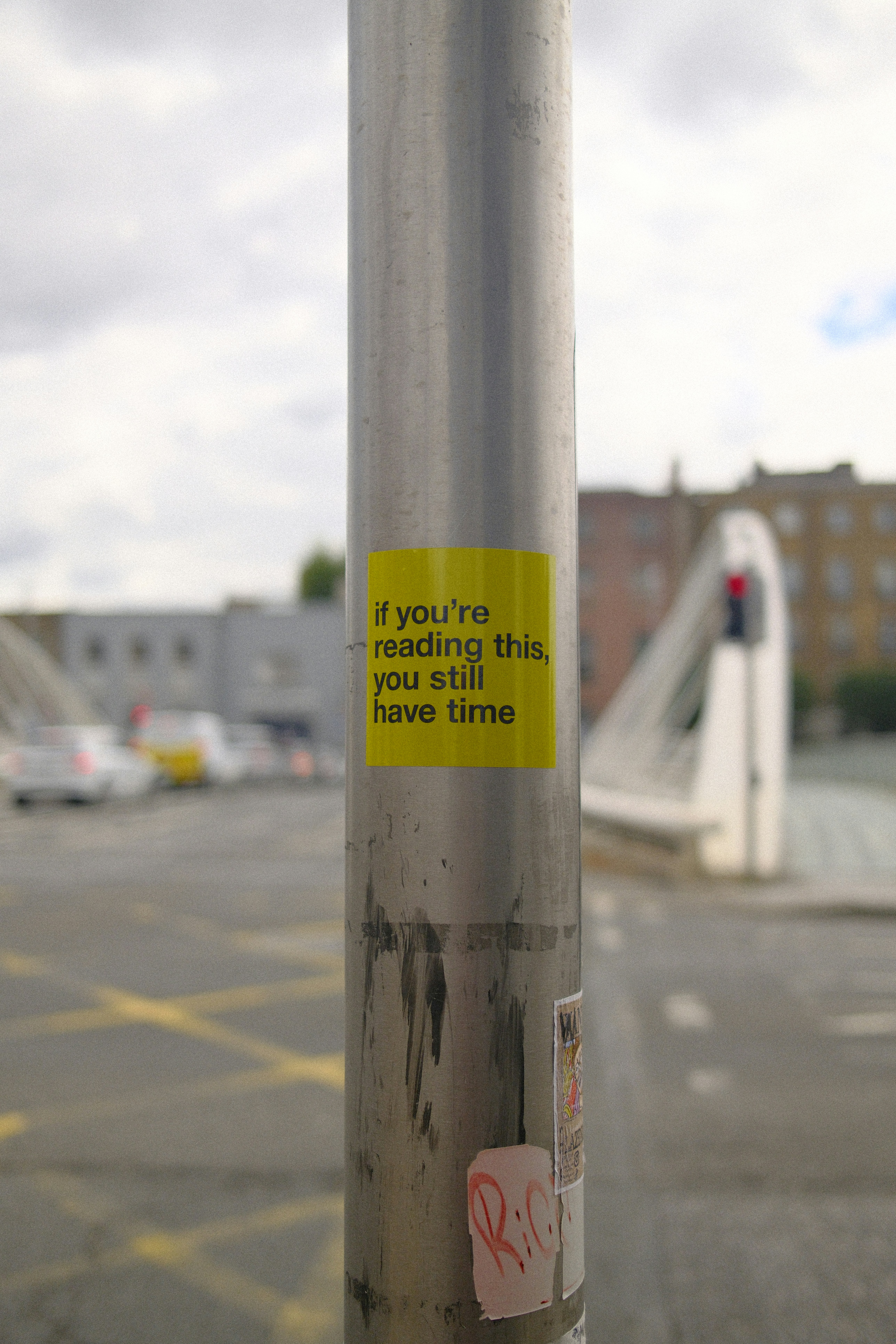 A sticker on a pole states "you still have time."