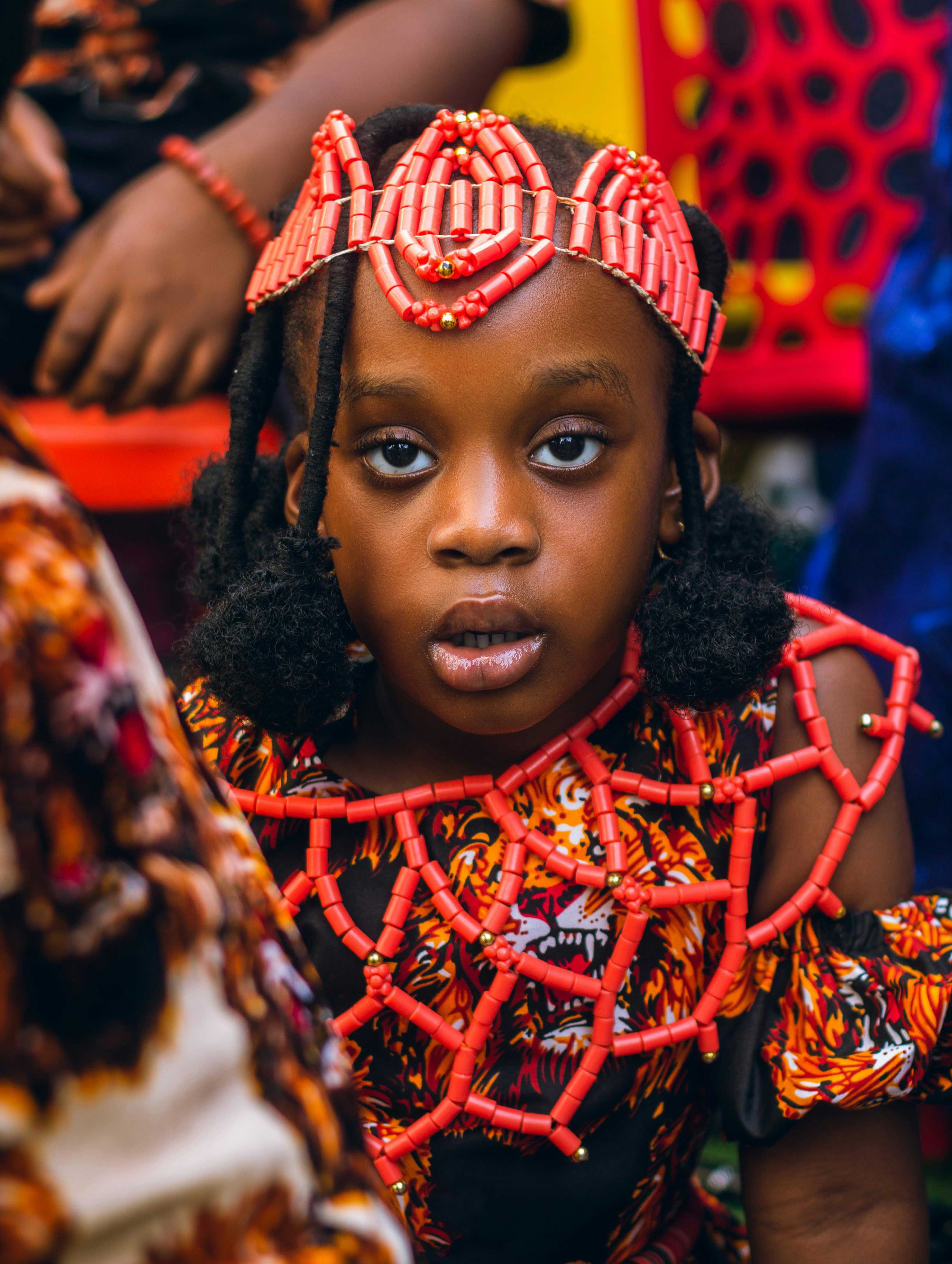 A young girl wears a beautiful crown.