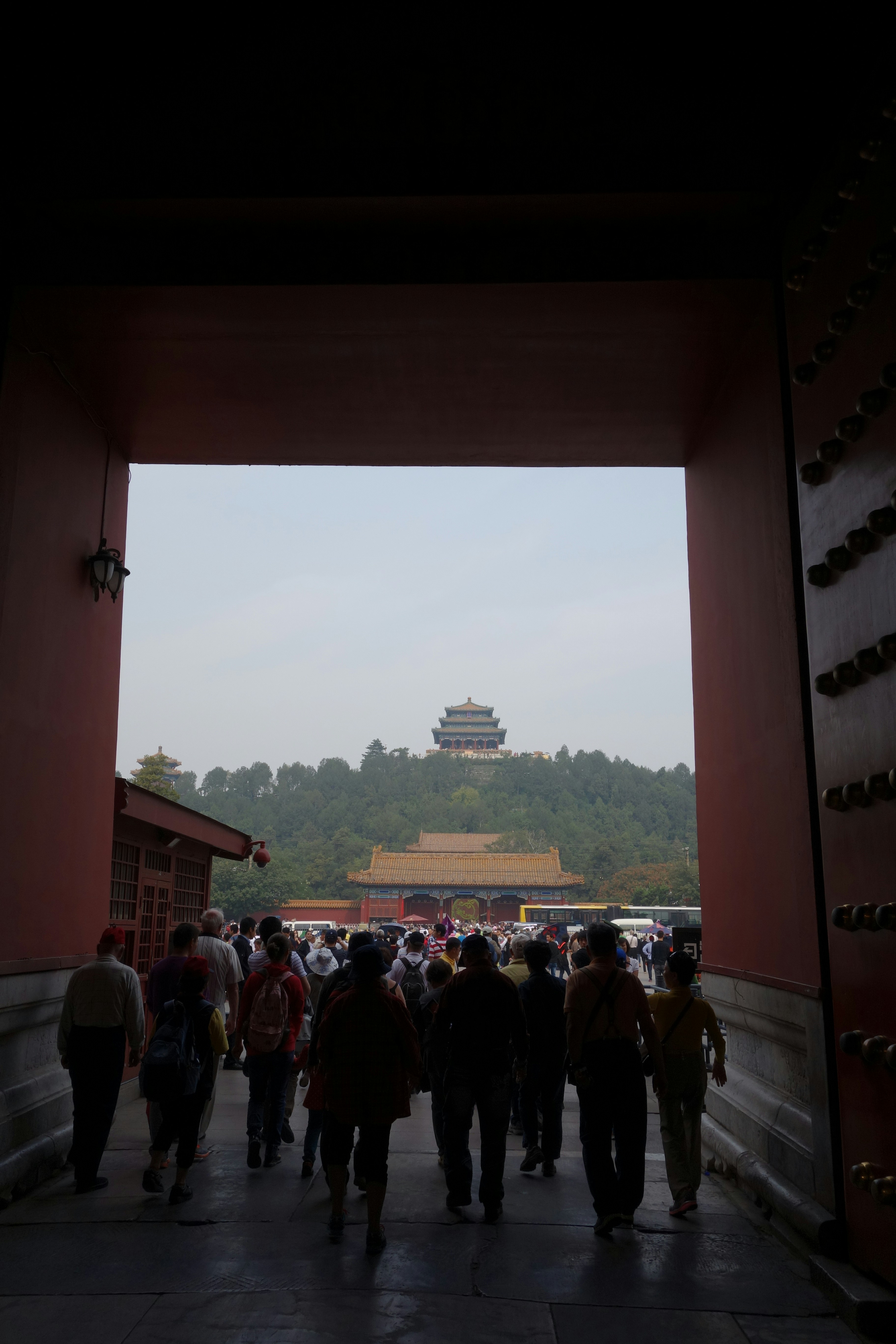 People walk toward an ancient building in china.