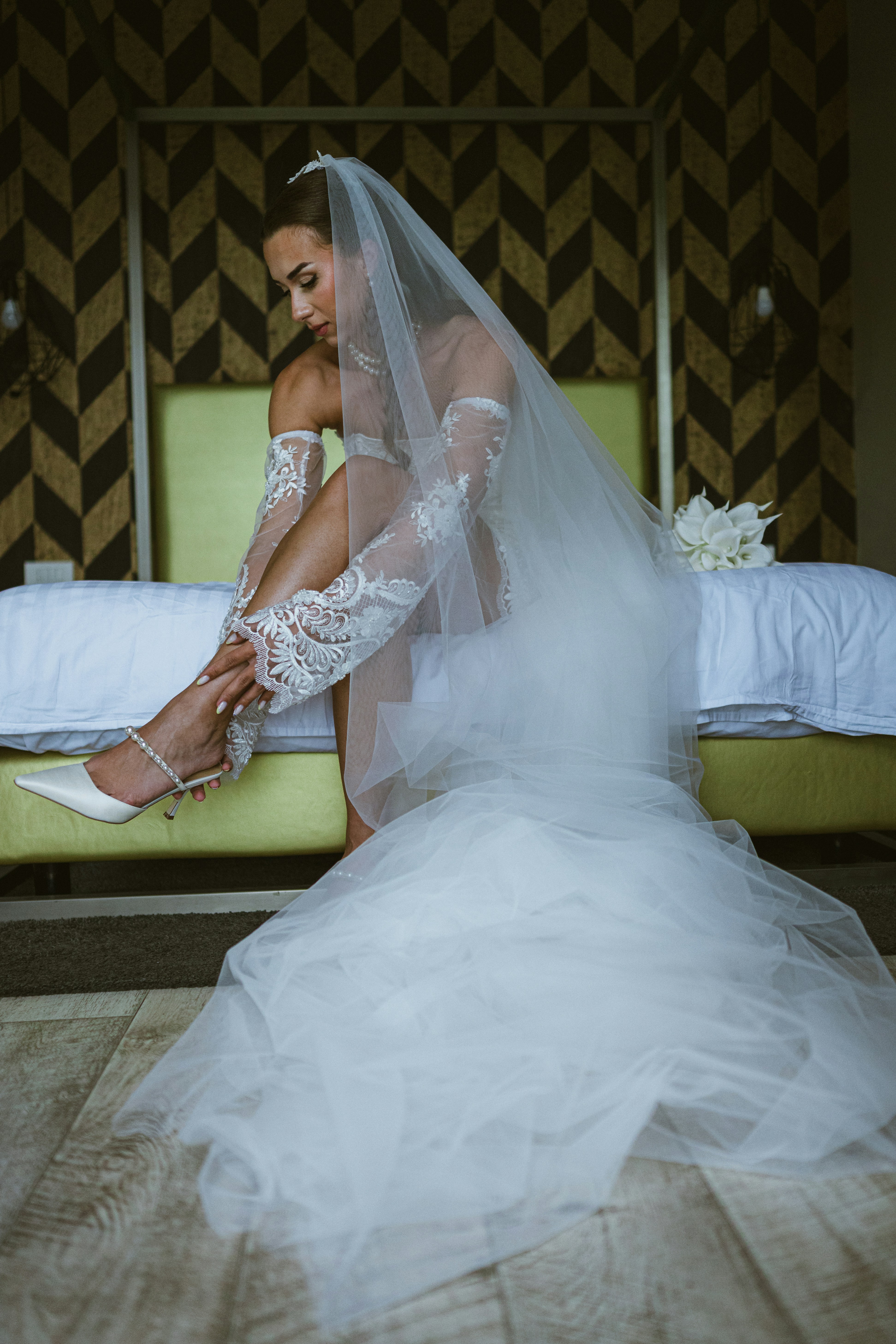 The bride is putting on her shoe.