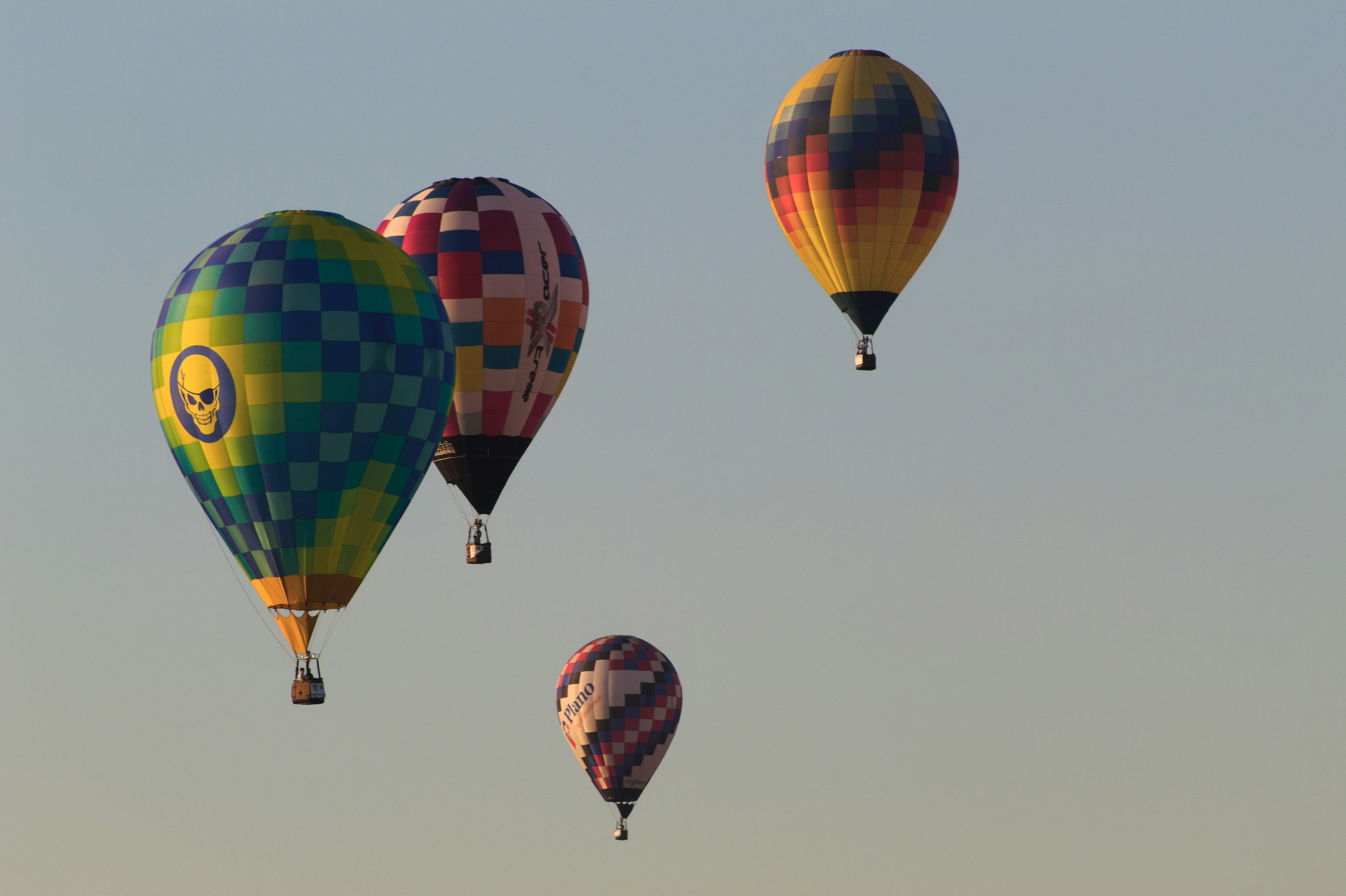 Several colorful hot air balloons floating in the sky