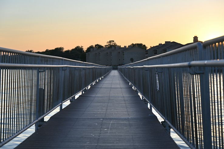 A long walkway leads towards a building.