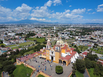 Aerial view of a church in a sprawling city.