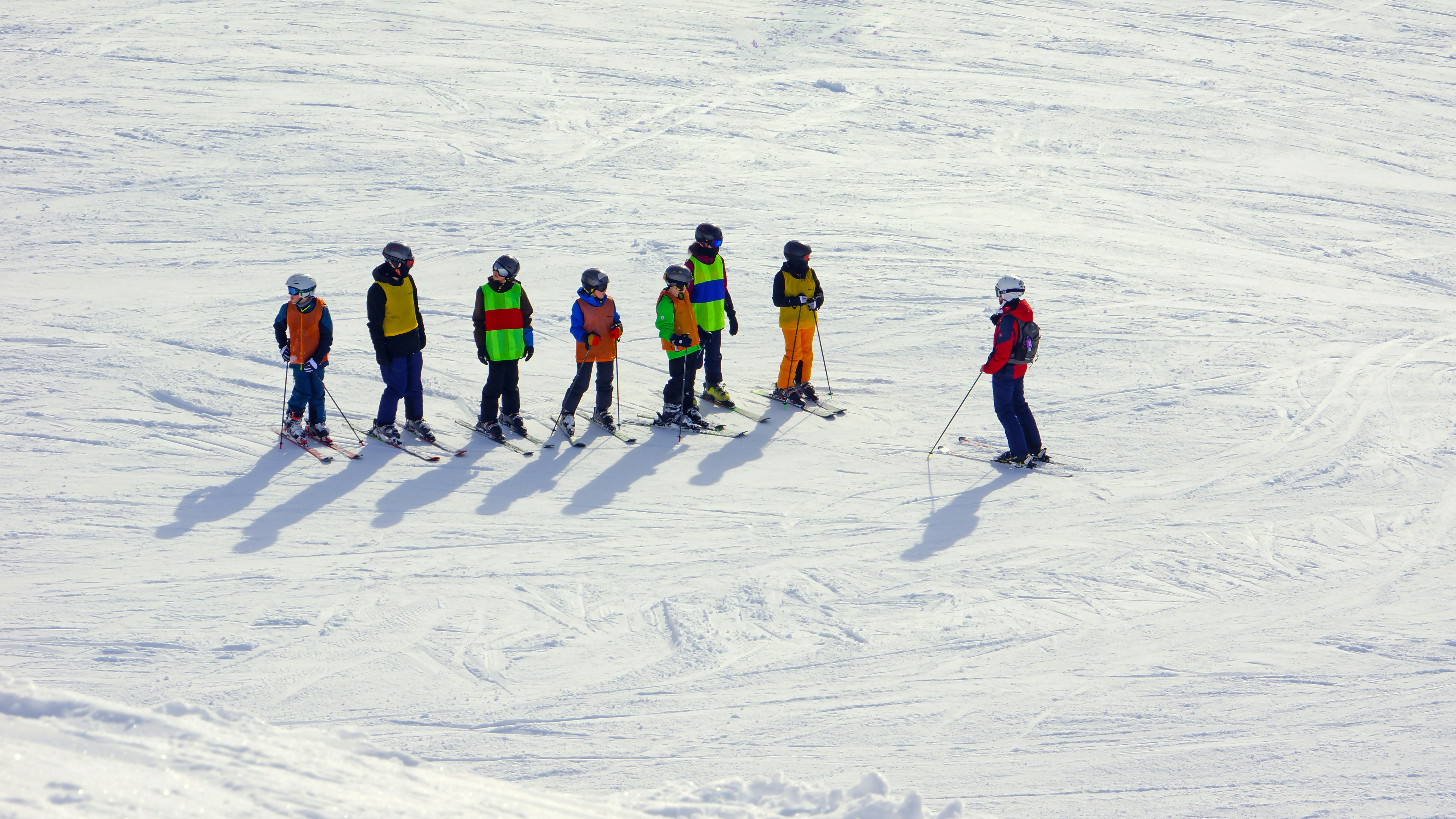 Skiers standing in snow