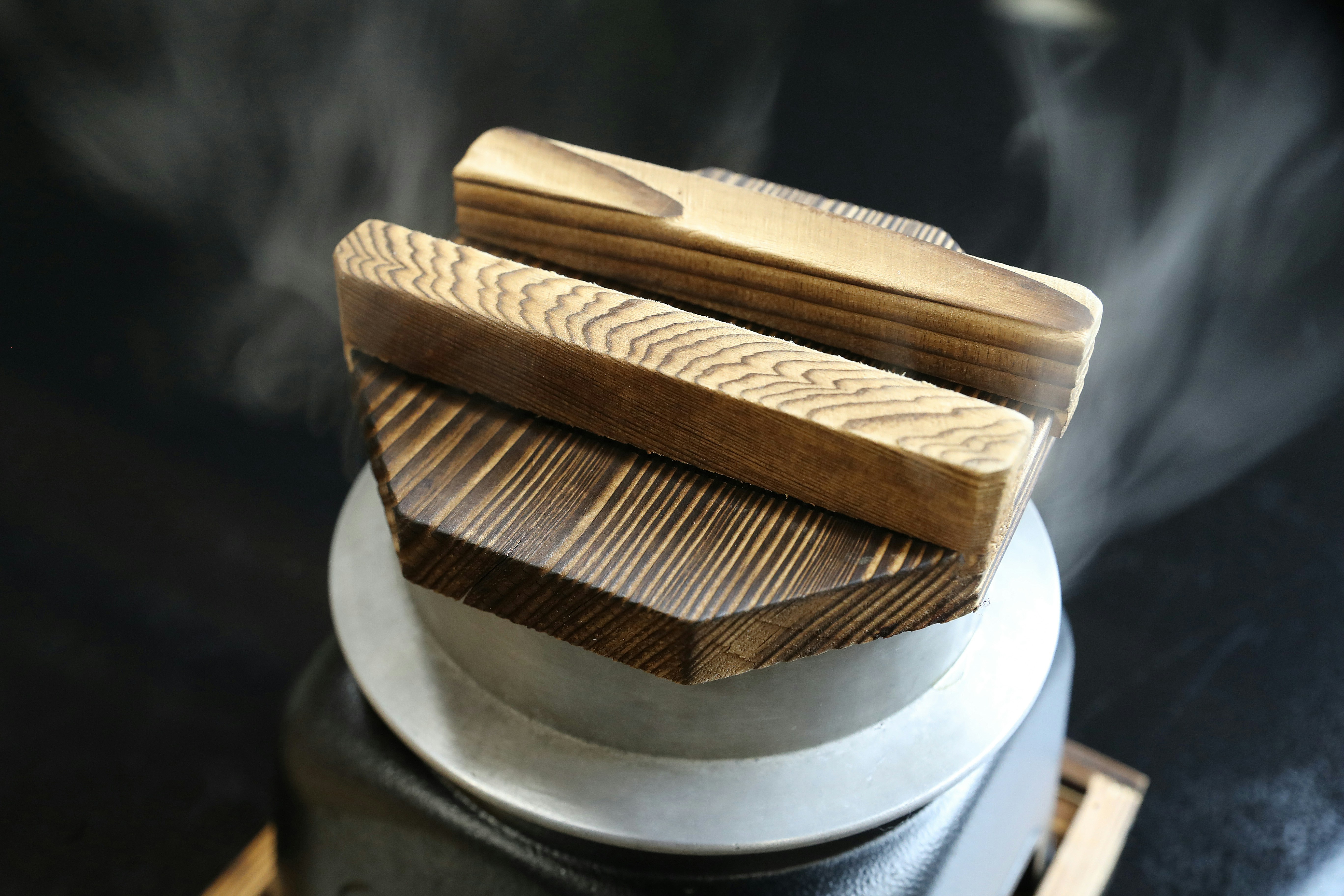 Steaming wooden blocks are emerging from below.