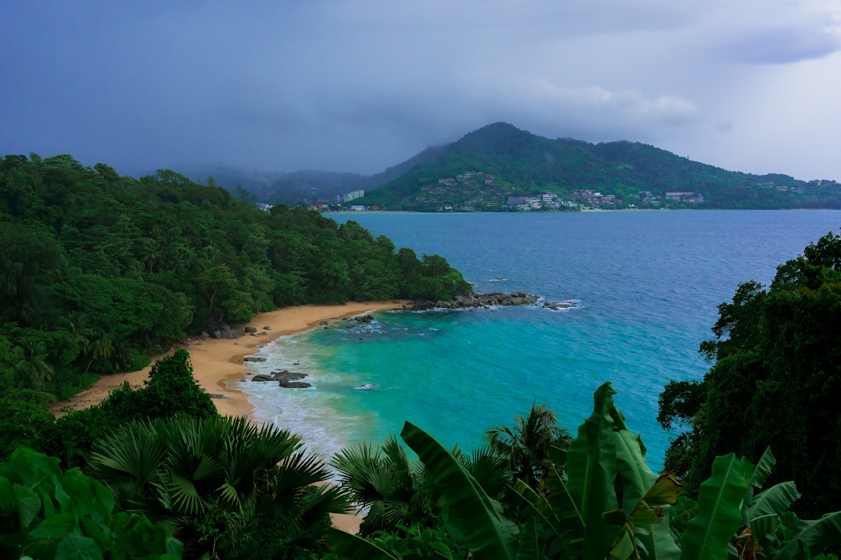 Kata Beach Phuket — long arc of golden sand meeting lush green hillside south of Patong