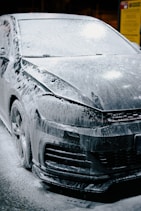 A car is being covered in soap.