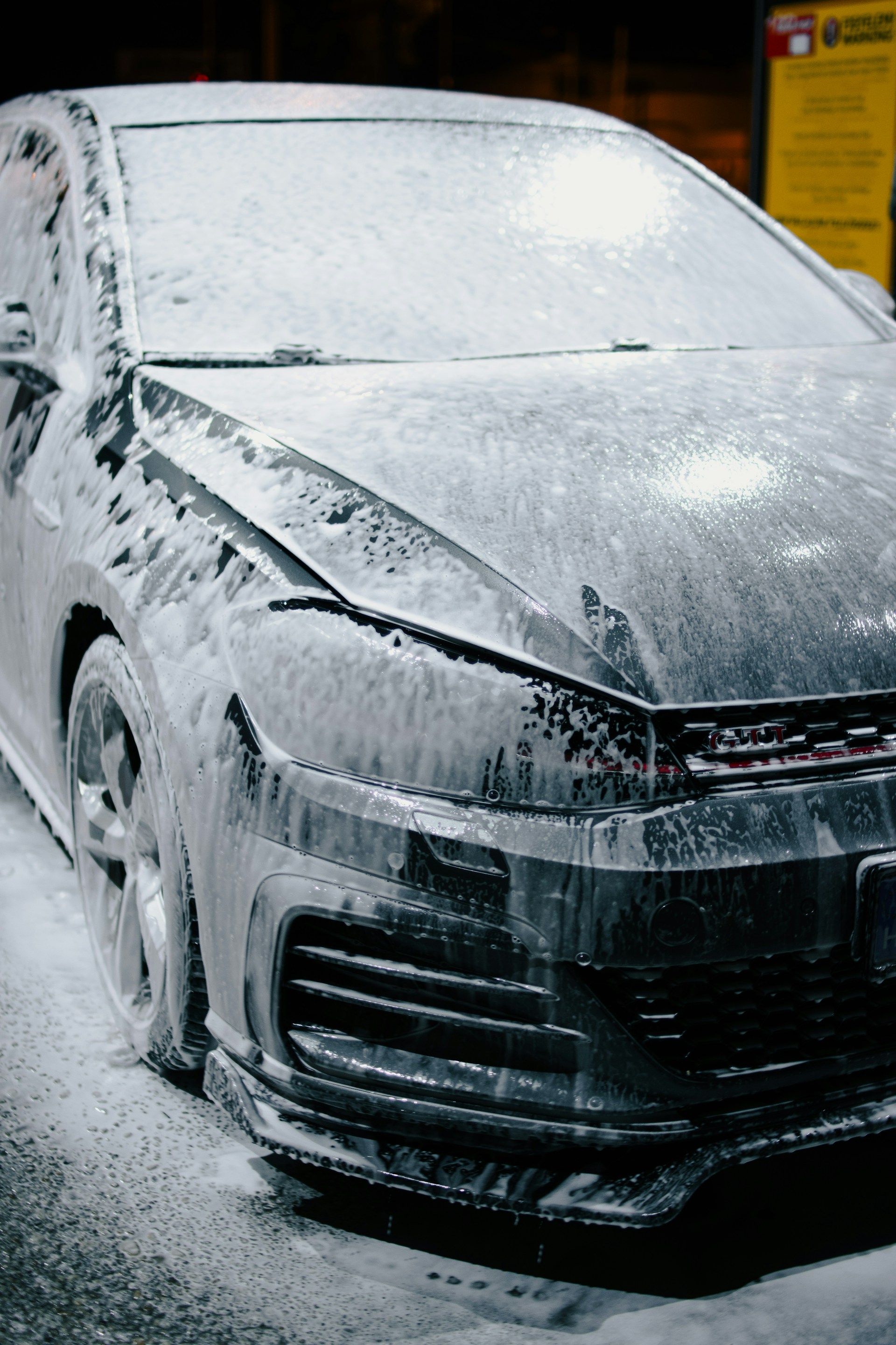 A car is being covered in soap.