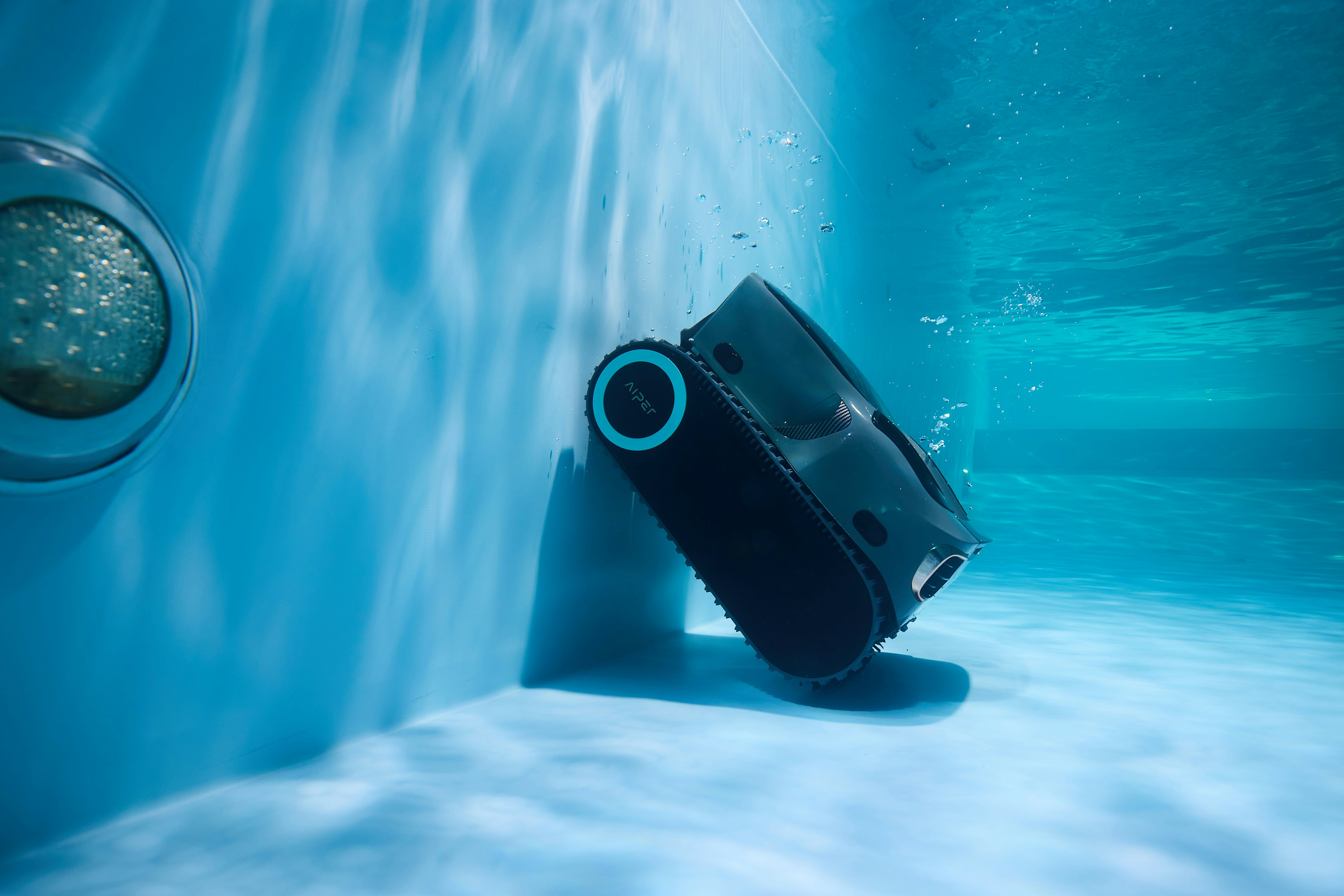 A robotic pool cleaner is working underwater.