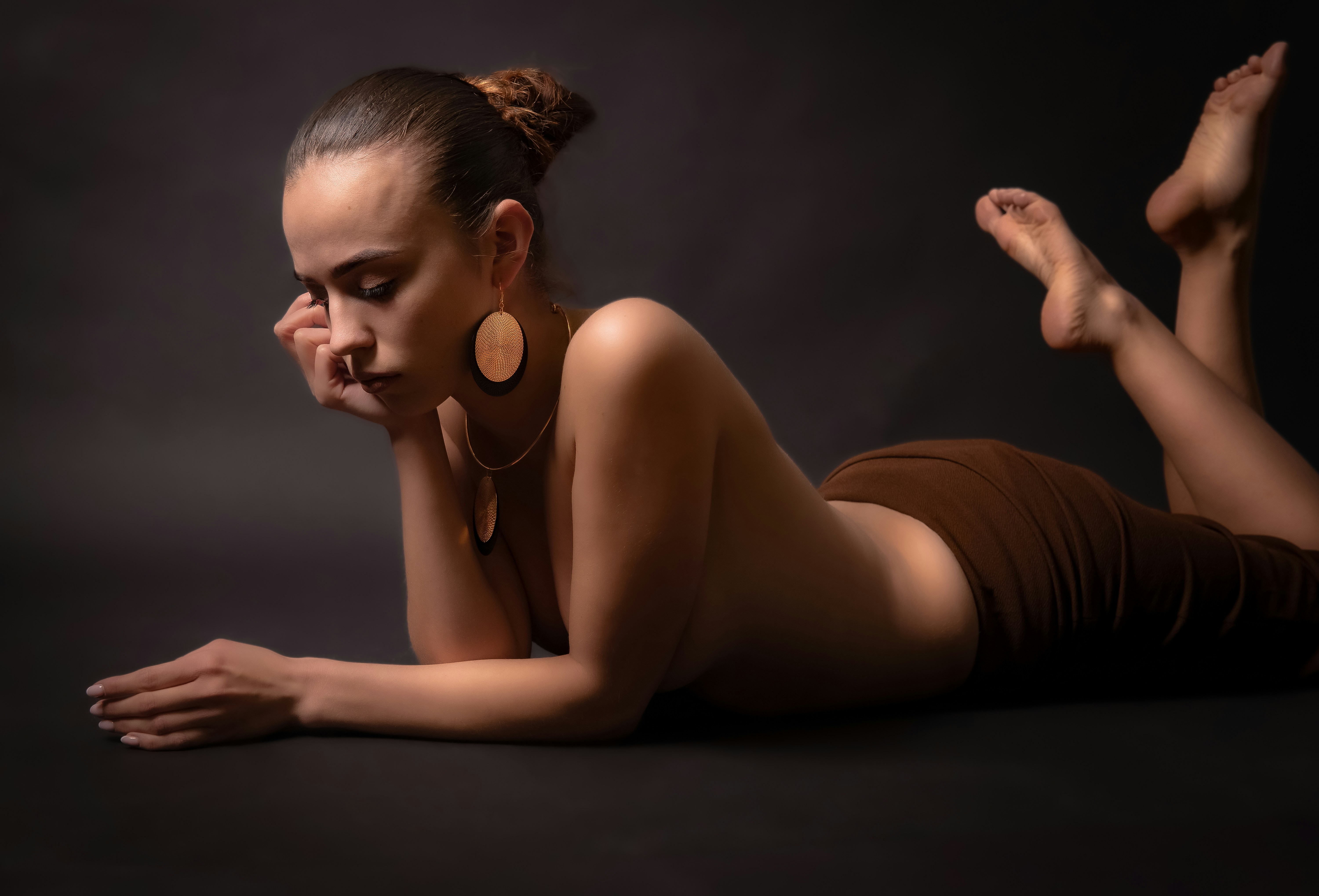 A woman poses, elegant and reclining.