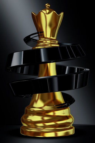 A golden queen chess piece with black swirl.