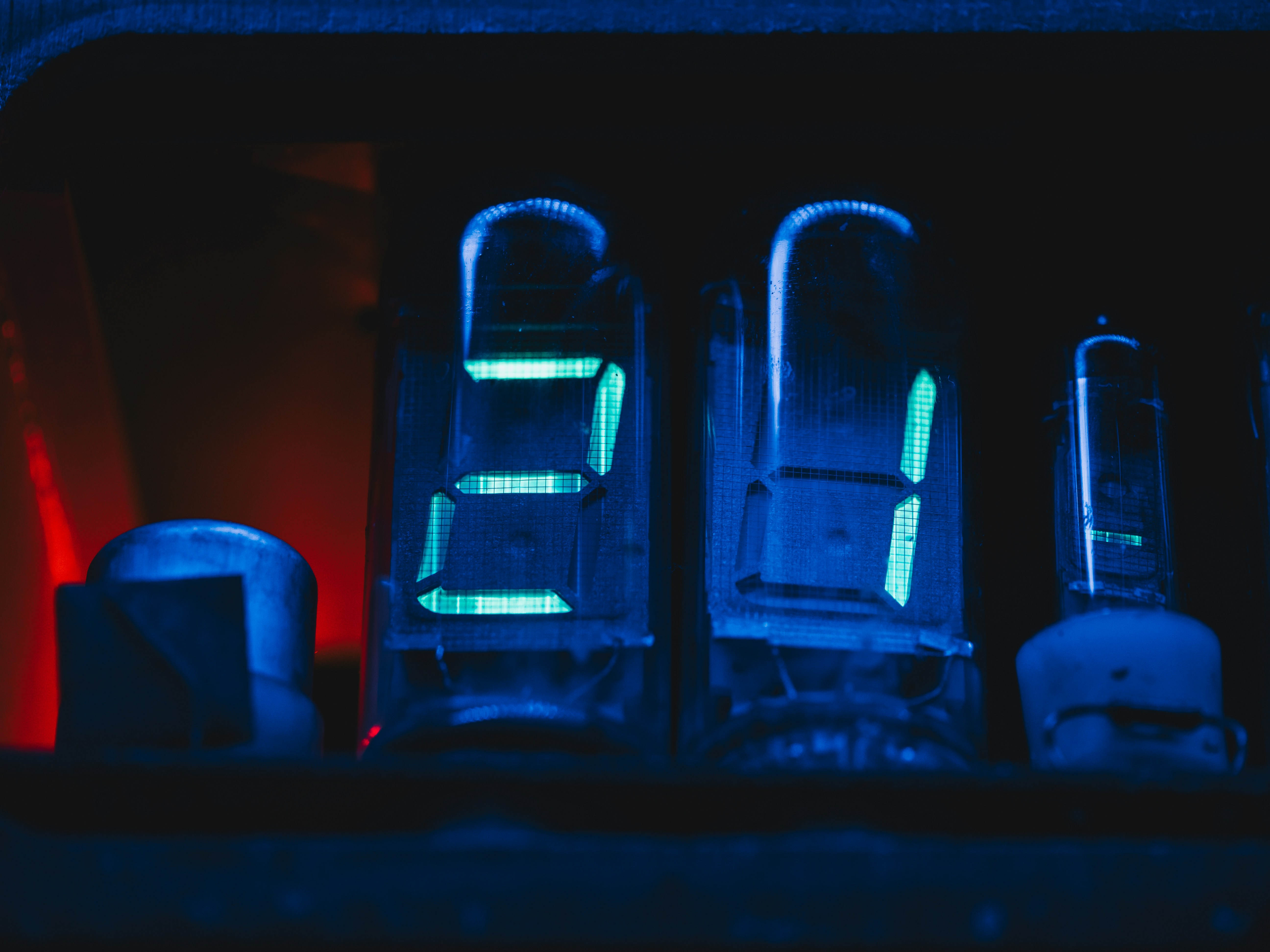The image shows illuminated nixie tube digits.