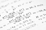 Mathematical formulas are shown on the paper.