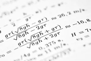 Mathematical formulas are shown on the paper.