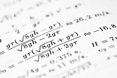 Mathematical formulas are shown on the paper.