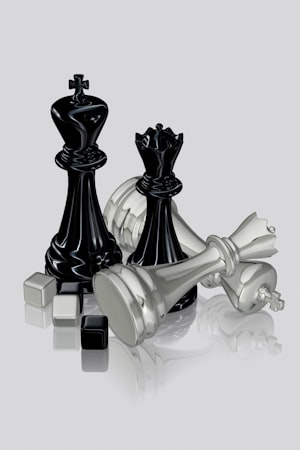 Chess pieces in a dramatic arrangement on a board, queen and rooks in focus