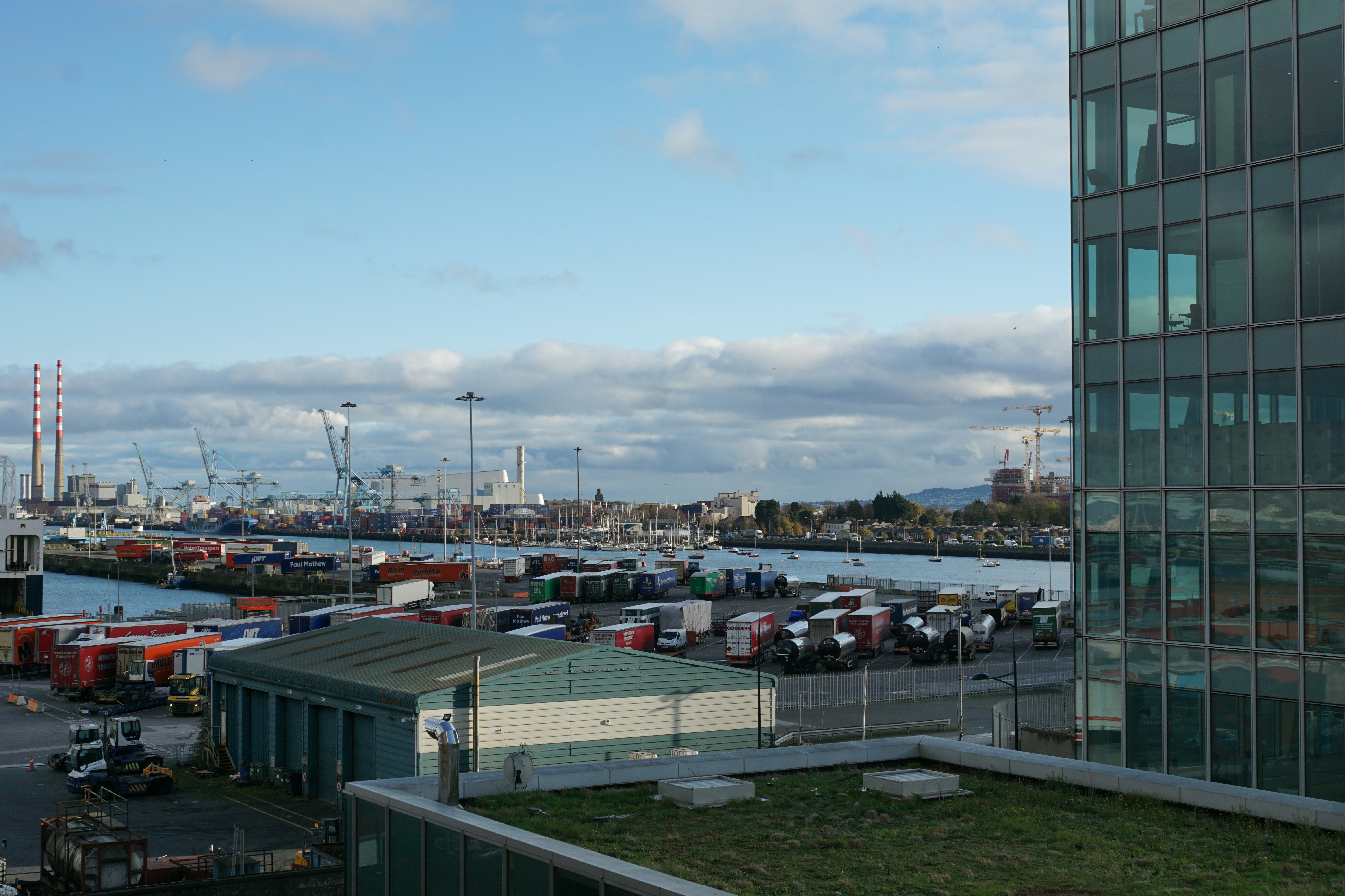 The image shows a harbor with a cloudy sky.