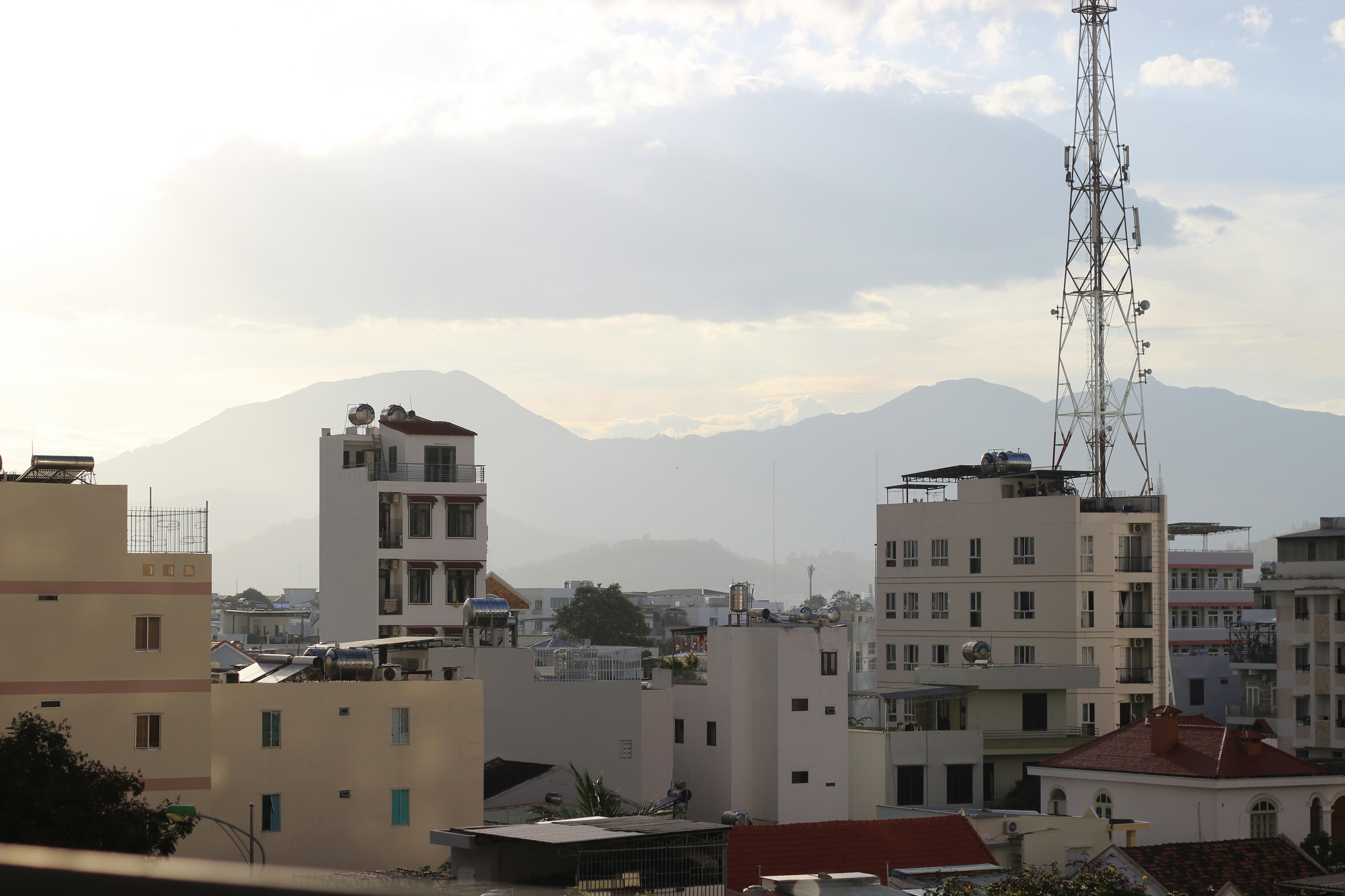 Cityscape with mountains in the distance.