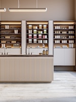 A minimalist shop with shelves and products.