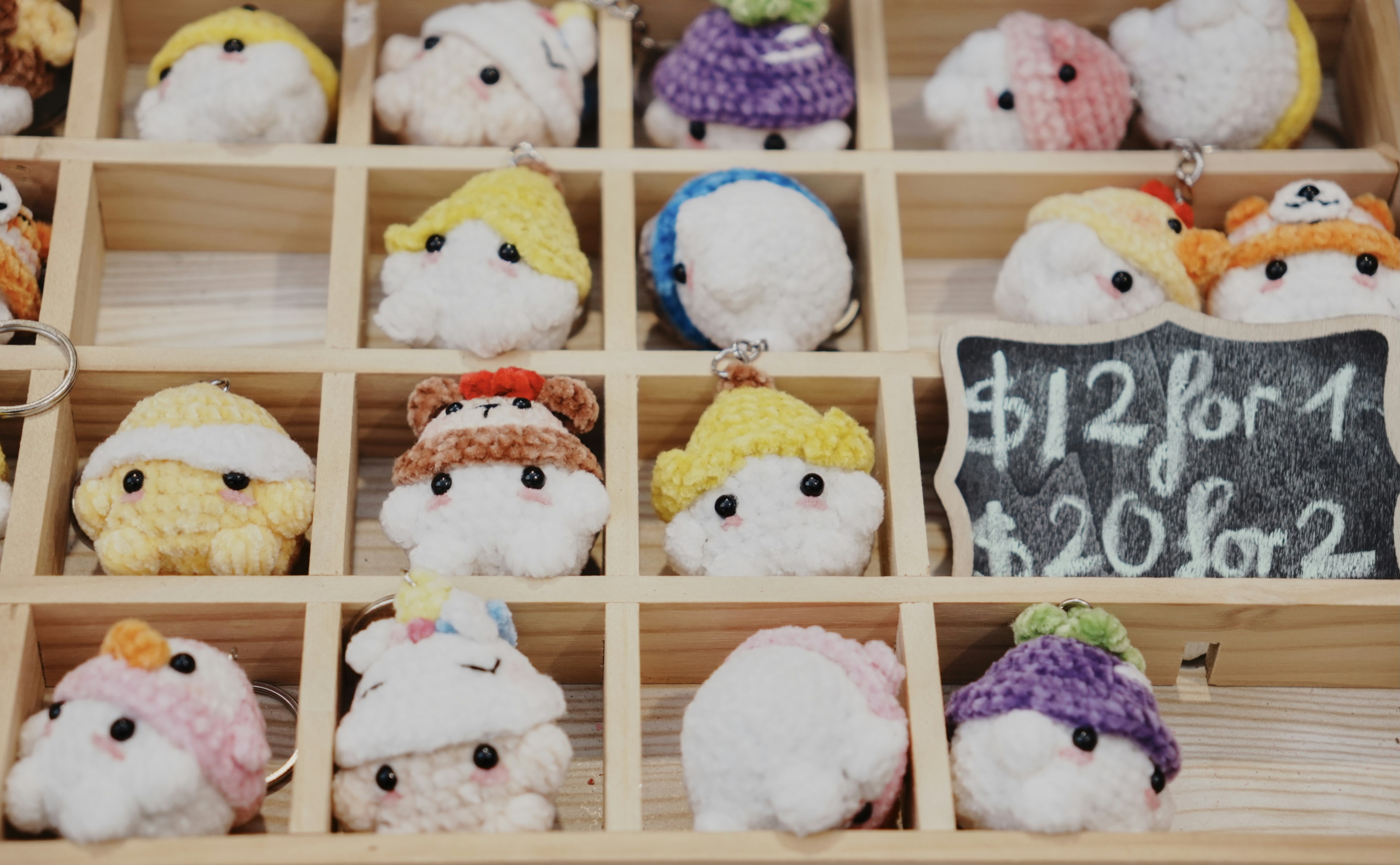 Cute plush toy keychains are displayed for sale.