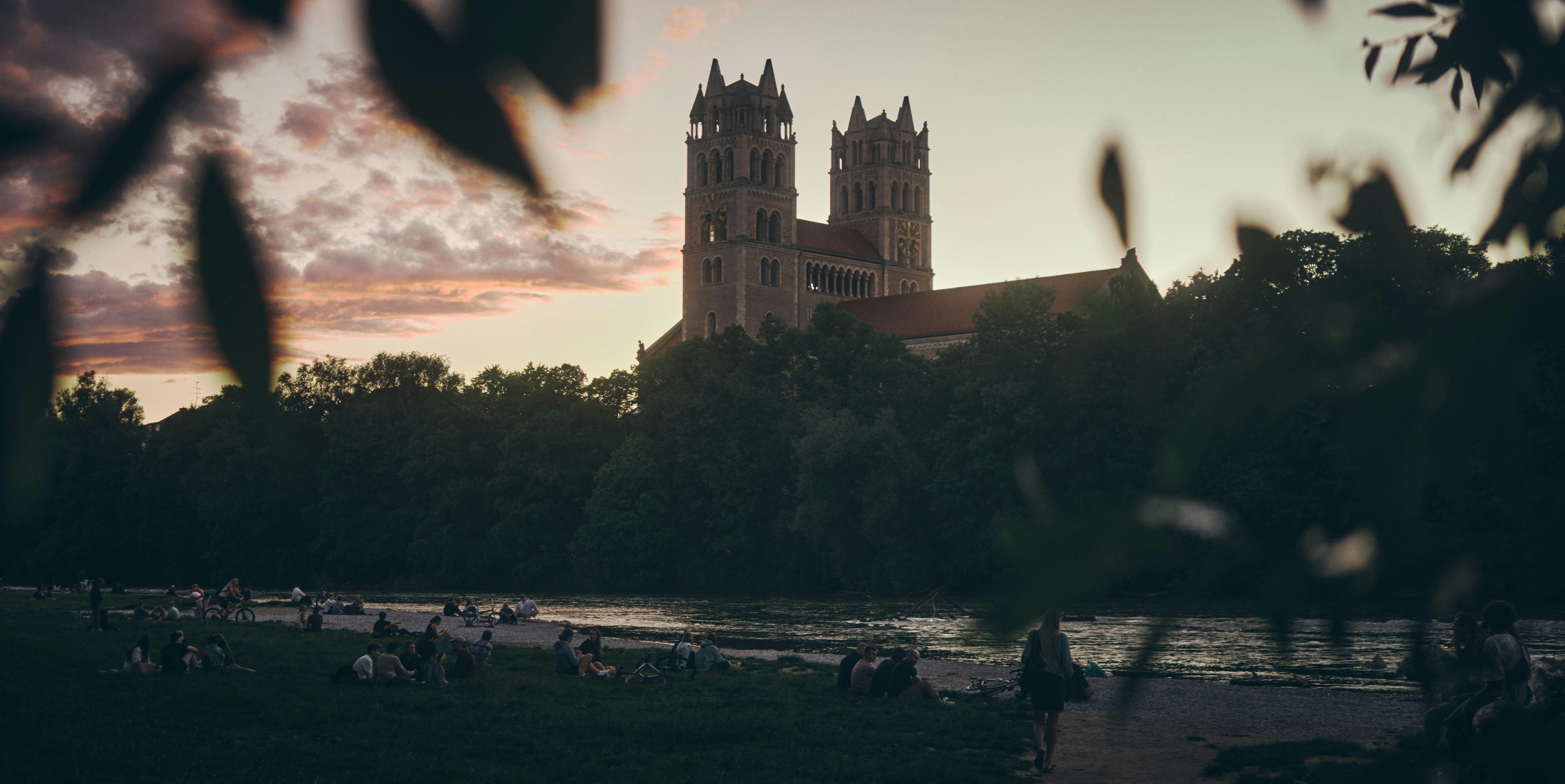 Church at sunset, with people on the green.