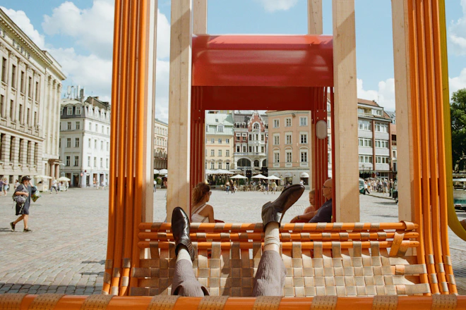 People relax in a colorful outdoor structure