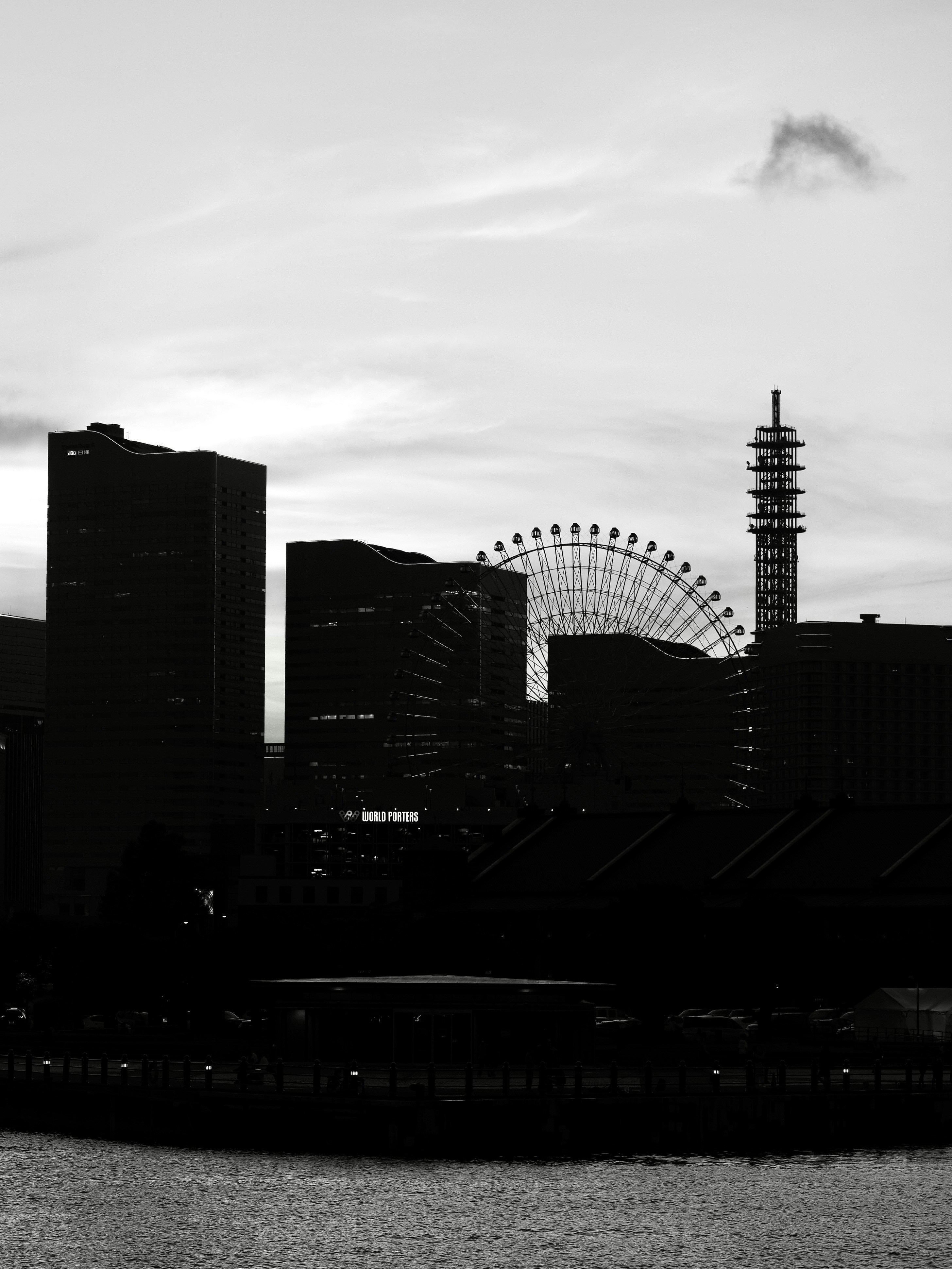 City skyline features a ferris wheel and a tower.