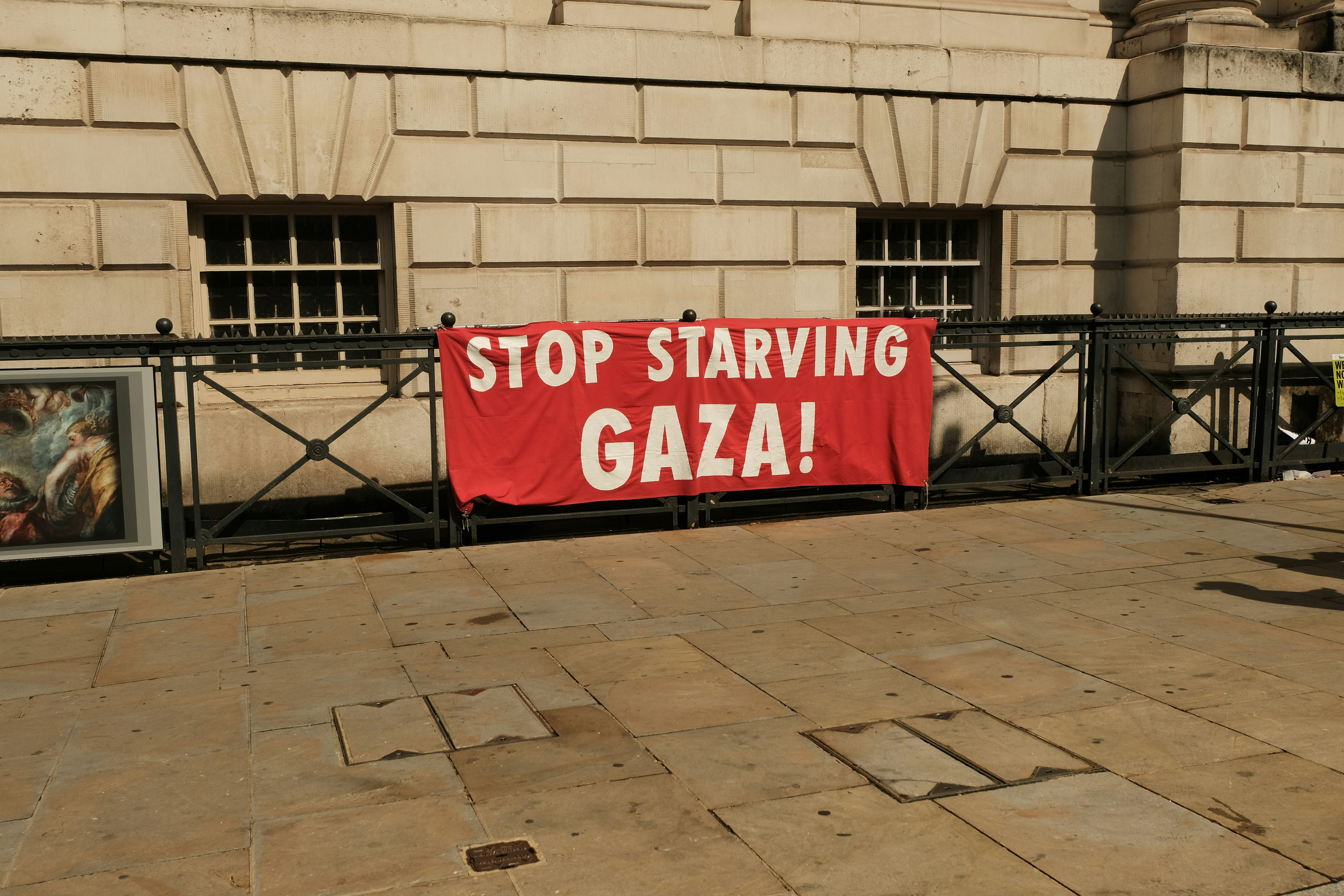 A banner protests the starving of gaza.