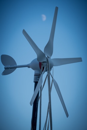 Wind turbine with the moon in the background.