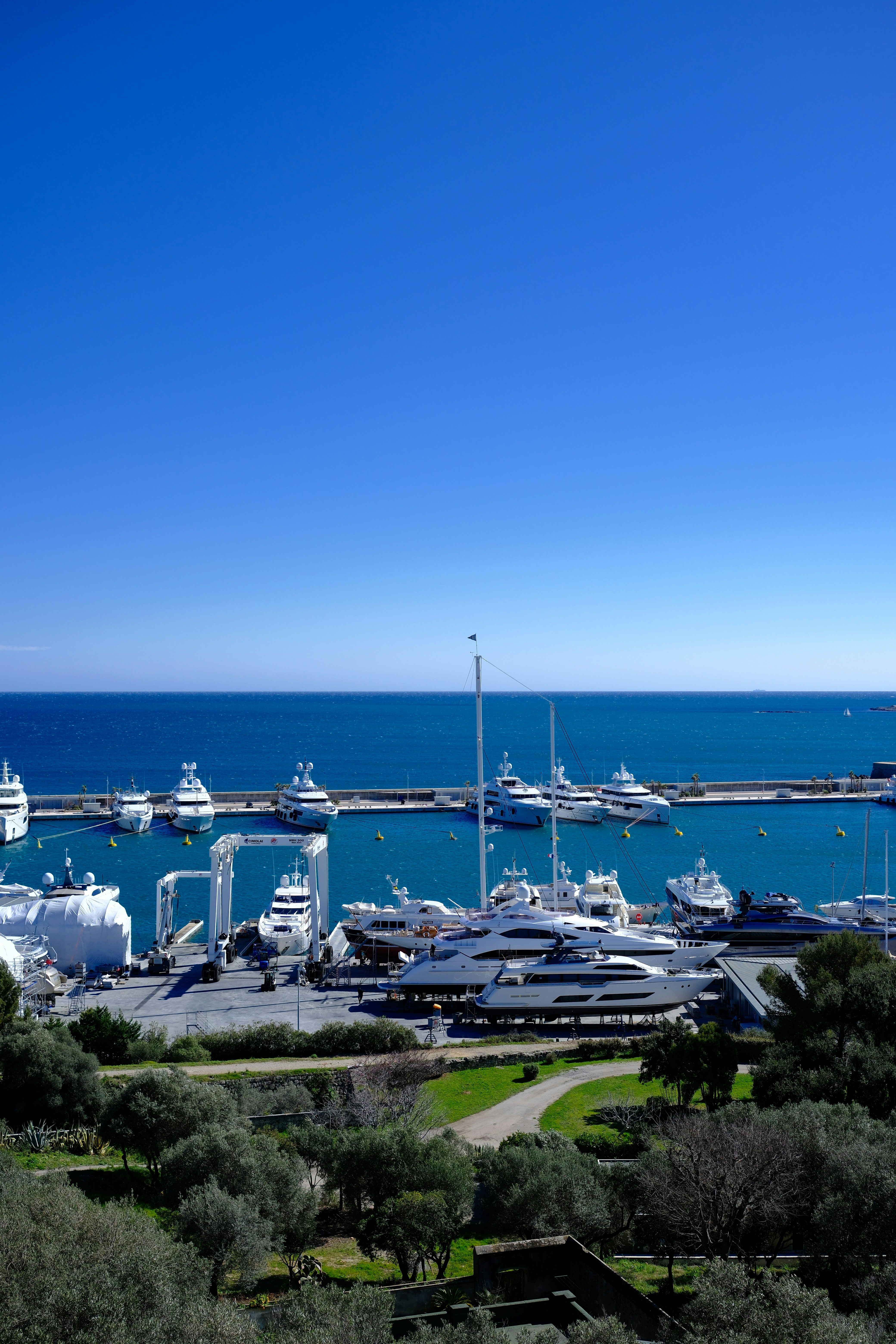 Luxury yachts docked in a beautiful harbor.