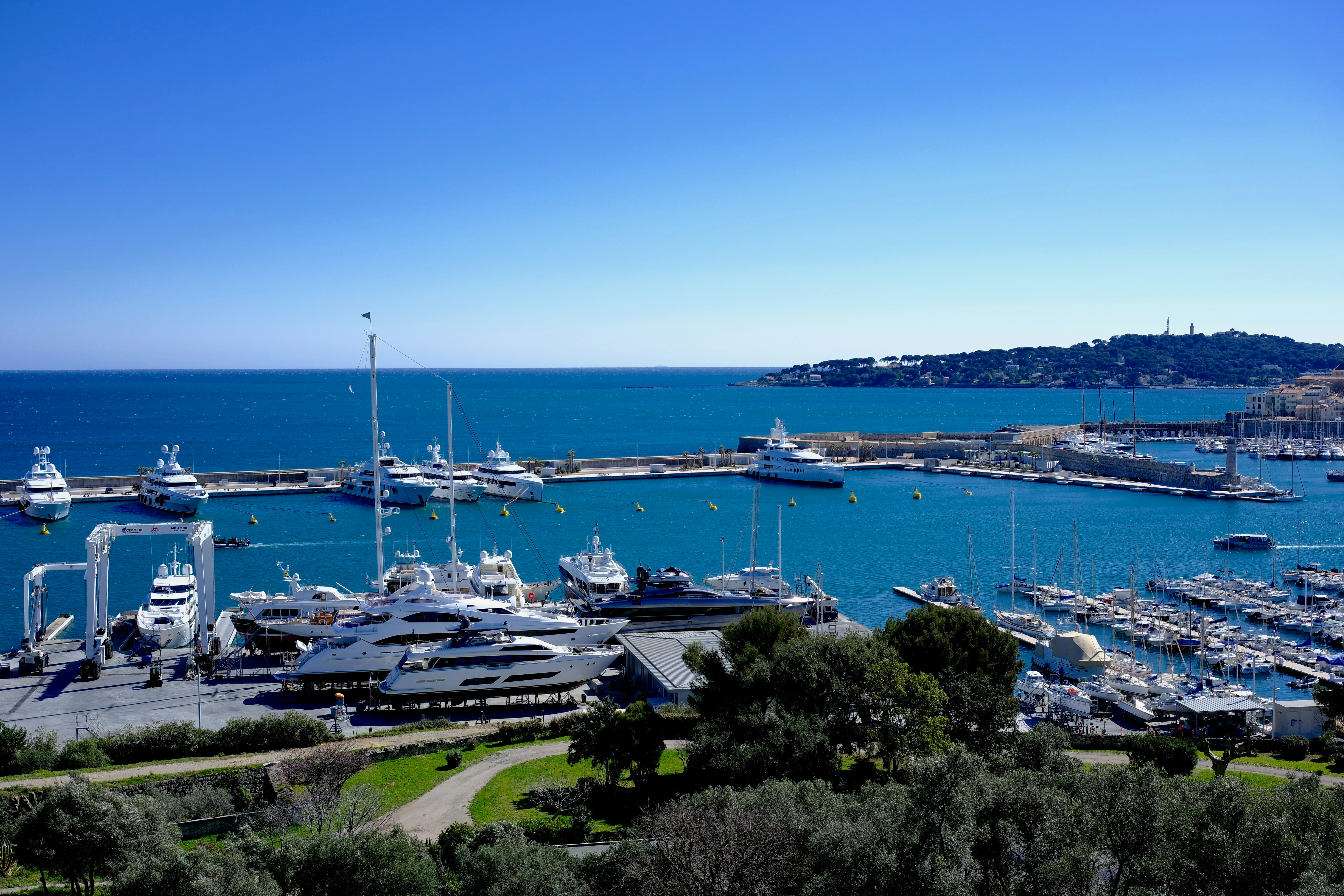 Luxurious yachts are moored in the beautiful harbor.